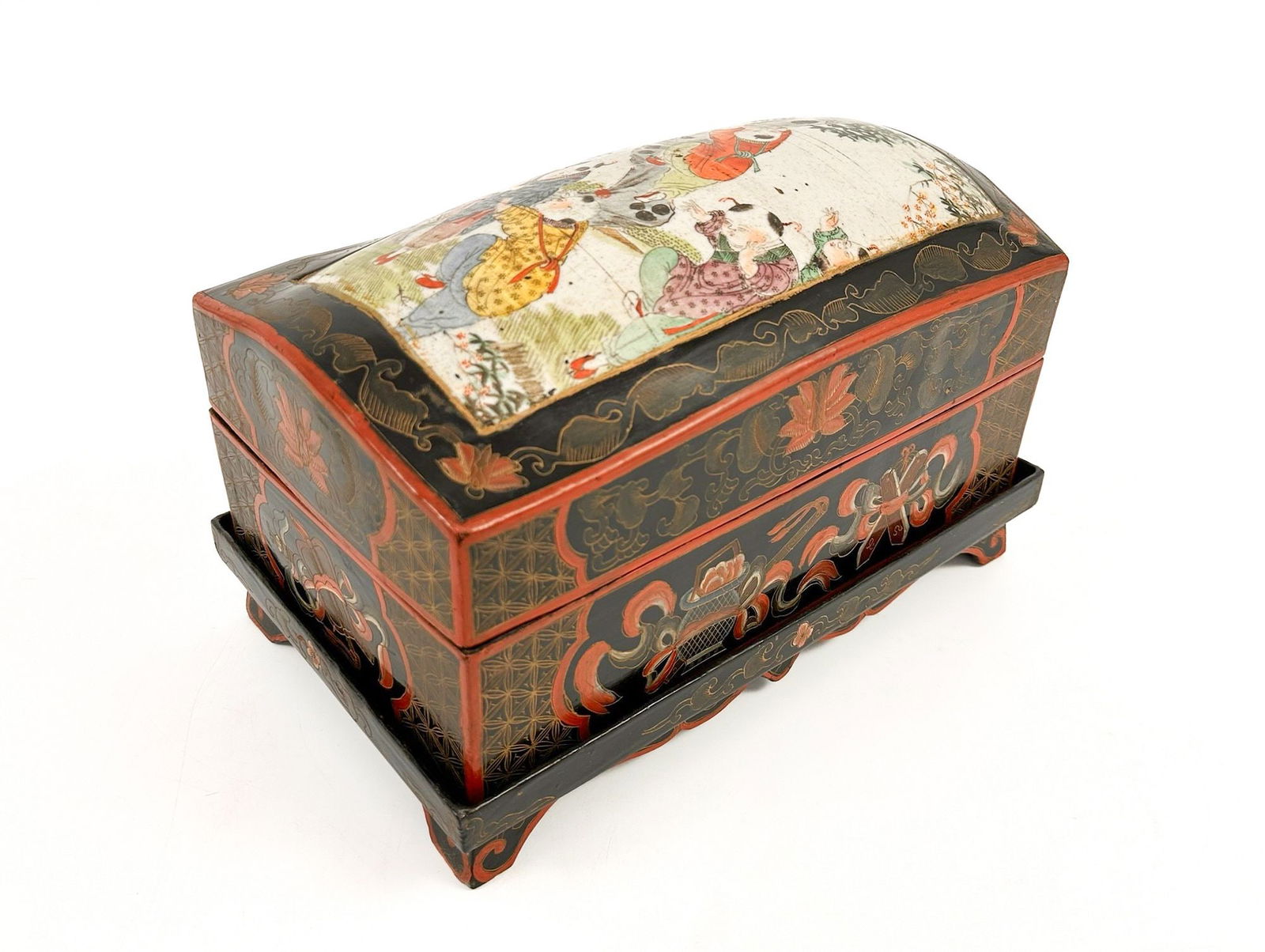Antique Chinese Lacquered Wood Box With Ceramic Inlay: Lidded box sits on a pedestal. Box features ceramic inlay painted to depict children playing. Traditional patterns and motifs throughout.Dimensions: Approximately 7.75 in H x 12.5 in W x 7.75 in D. Ap