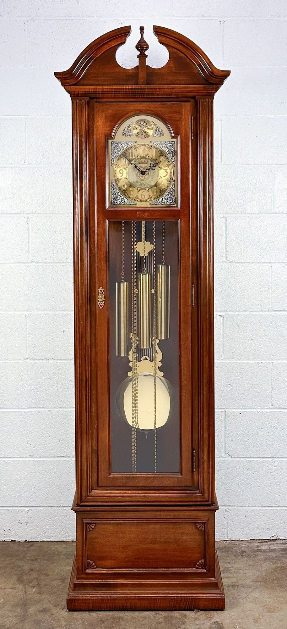 Seth Thomas Tempus Fugit Grandfather Clock: Grandfather clock w/ finial and metal face.Dimensions: Clock is approx. 78.5 in H x 23 in W x 12 in D.
