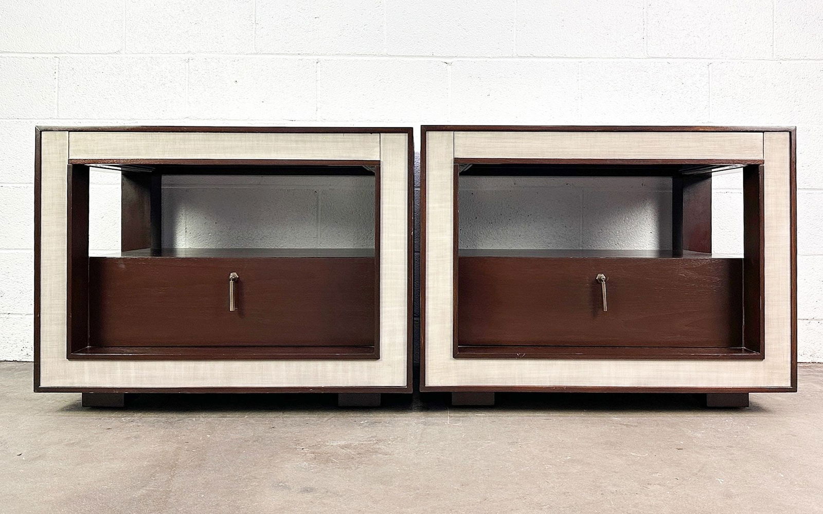 Pair Michael Berman Midcentury Side Tables W/ Hidden Drawer: Pair of end tables with dark mahogany trim and light gray panels. Label inside drawer.Dimensions: Each table is approx. 26 in H x 34 in W x 23 in D.