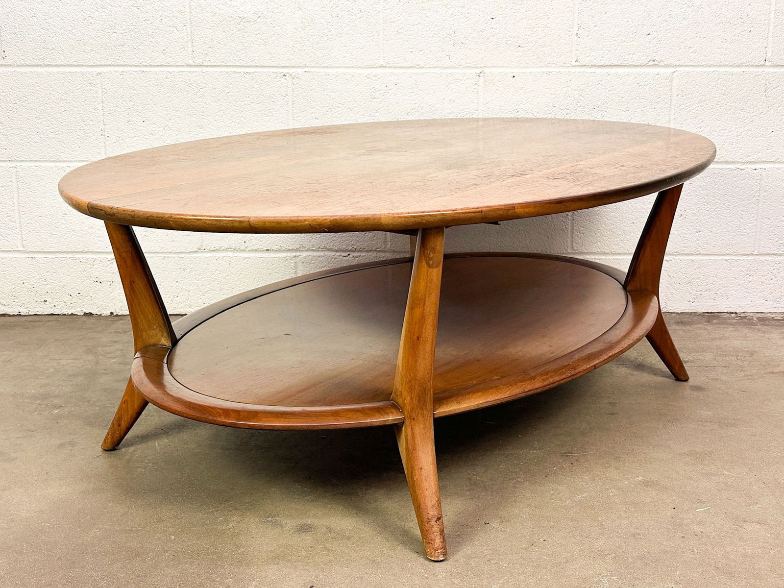 Henredon Midcentury Two Tiered Oval Coffee Table: Tiered coffee table with sleek Midcentury design.