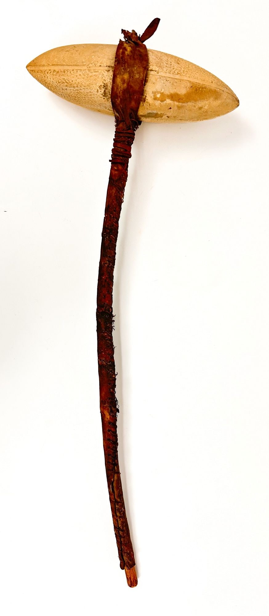 Sioux, Plains Stone Headed Club, Early 20th Century, Great Plains American Indian: Carved stone head with leather wrapped wooden handle. Sinew sewn. Dimensions: Approximately 15.5 in H x 6 in W x 2.25 in D. Weighs approximately 1 lbs.