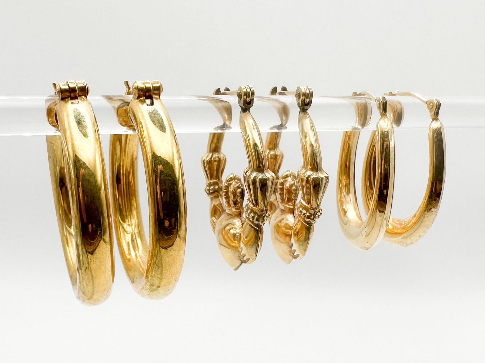 Lot of 3 Pairs 14K Yellow Gold Hoop Earrings: Round, Oval, and Claddagh Heart Designs: Sizes are 1 1/8 inch, 1 inch, and 3/4 inch across. Ovals have small dent on bottom. Weighs 10.6 grams.