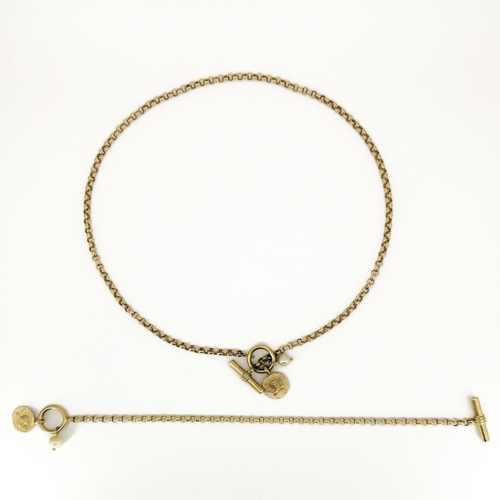 14K Gold Necklace & Bracelet Set with Pearl and Angel Charm: 14K yellow gold necklace and bracelet set. The necklace is 16 inches long, and the bracelet is 7 inches long. The set features a T-bar closure, pearl accents, and an angel charm. Total weight: 10.3 gr