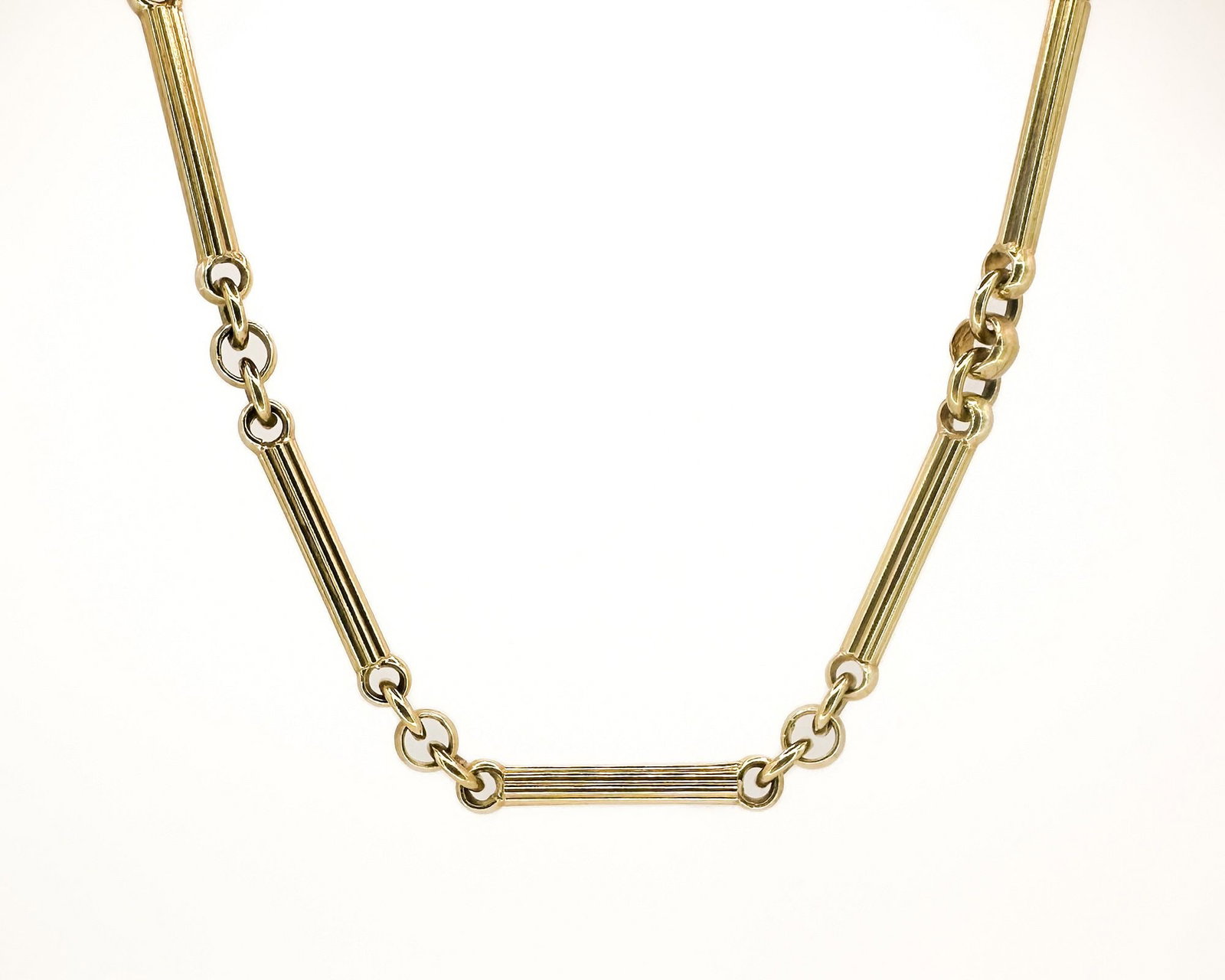 14K Yellow Gold Fluted Bar Link Necklace: 14K yellow gold necklace featuring fluted bar links connected by round links. Measures 18 inches in length and weighs 30.3 grams.