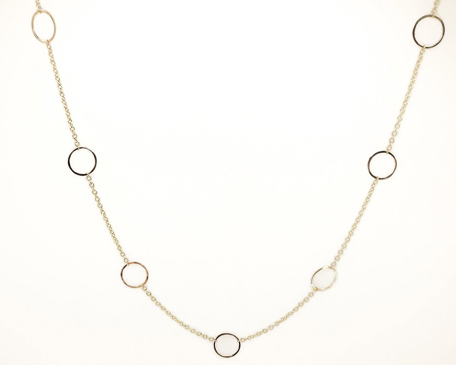 Zoe Chicco 14K Yellow Gold Nine Circle Link Necklace: Zoe Chicco 14K yellow gold necklace featuring nine open circle links on a fine chain. Measures 16 inches in length and weighs 1 gram. Hallmarked.