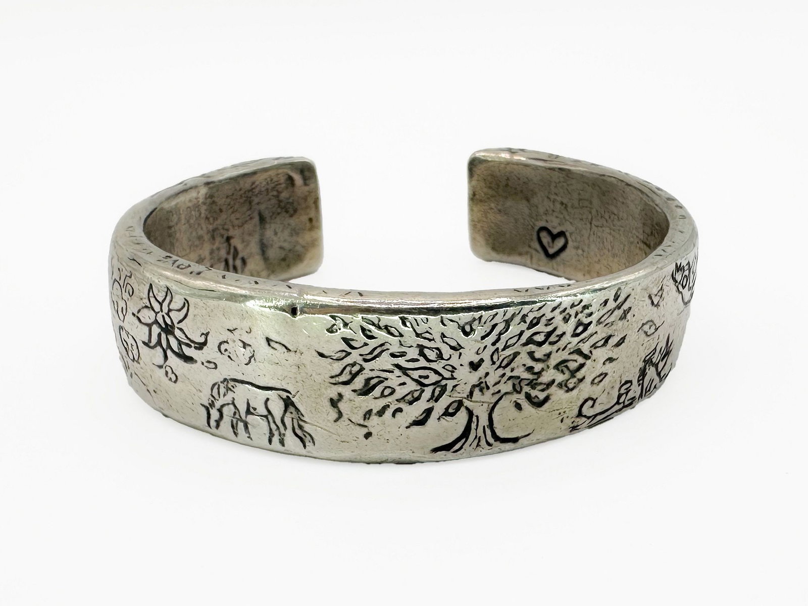 Jess MaHarry Rooted Strong Sterling Cuff Bracelet: Jess MaHarry sterling silver cuff bracelet featuring a 'Rooted Strong' design with tree, elephant, and floral motifs. Interior inscription. Measures 5 3/4" exterior, 6 1/2" interior.