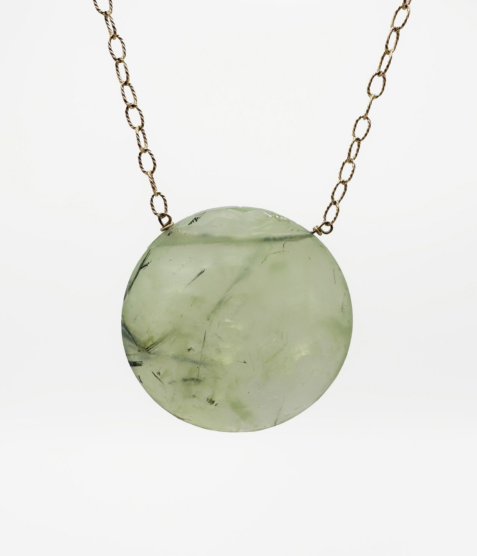 14K Gold Prehnite Pendant Necklace: 14K yellow gold necklace featuring a prehnite pendant. The chain is 20 inches long, and the pendant is 1 1/4 inches in diameter. Total weight: 12.9 grams.
