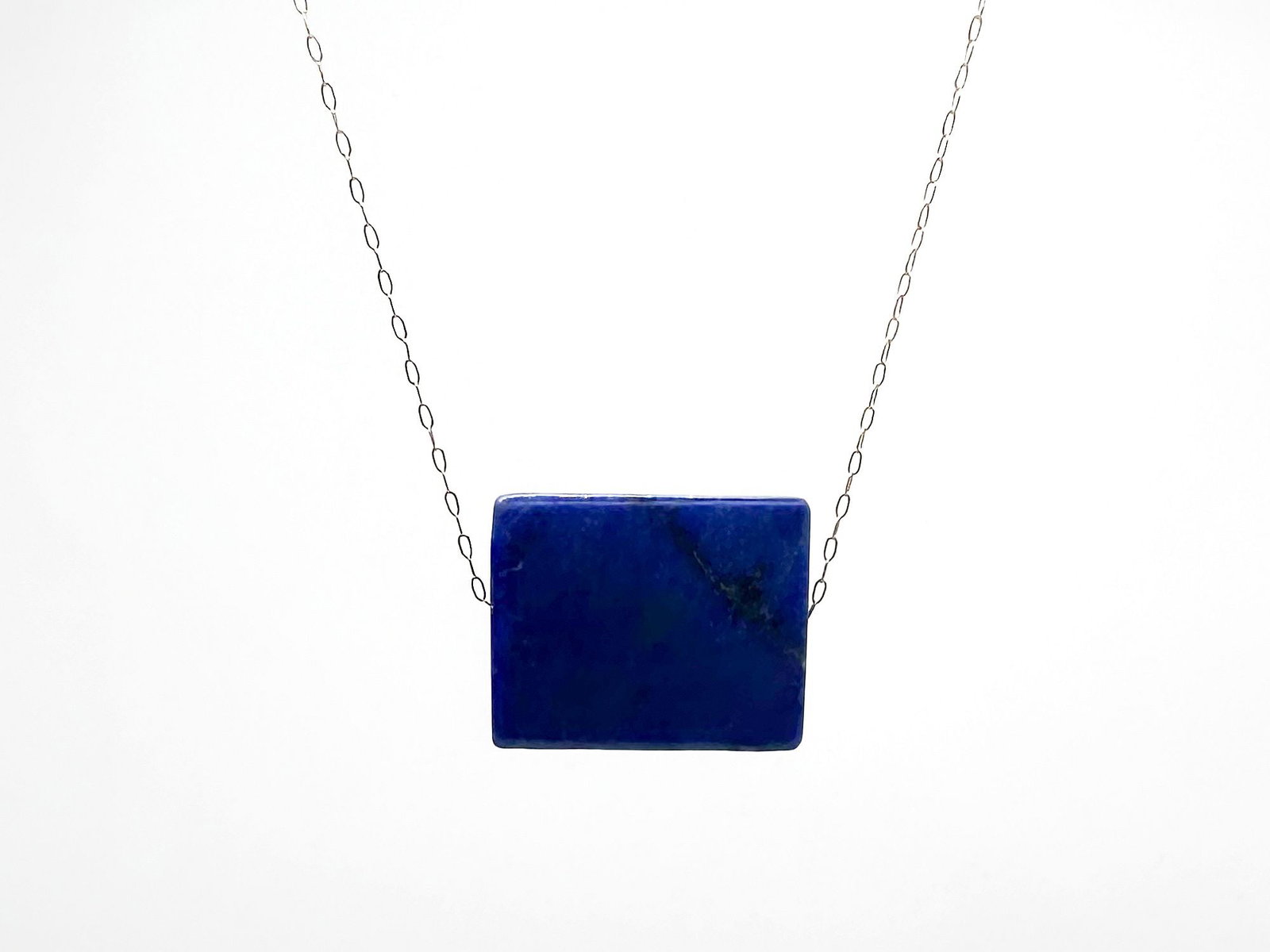 Margaret Solow 14K Gold and Lapis Pendant Necklace: Margaret Solow necklace featuring a rectangular lapis lazuli pendant on a 14K gold chain. The necklace is 16 1/4 inches long, and the pendant is 7/8 inches wide. The clasp is gold fill.