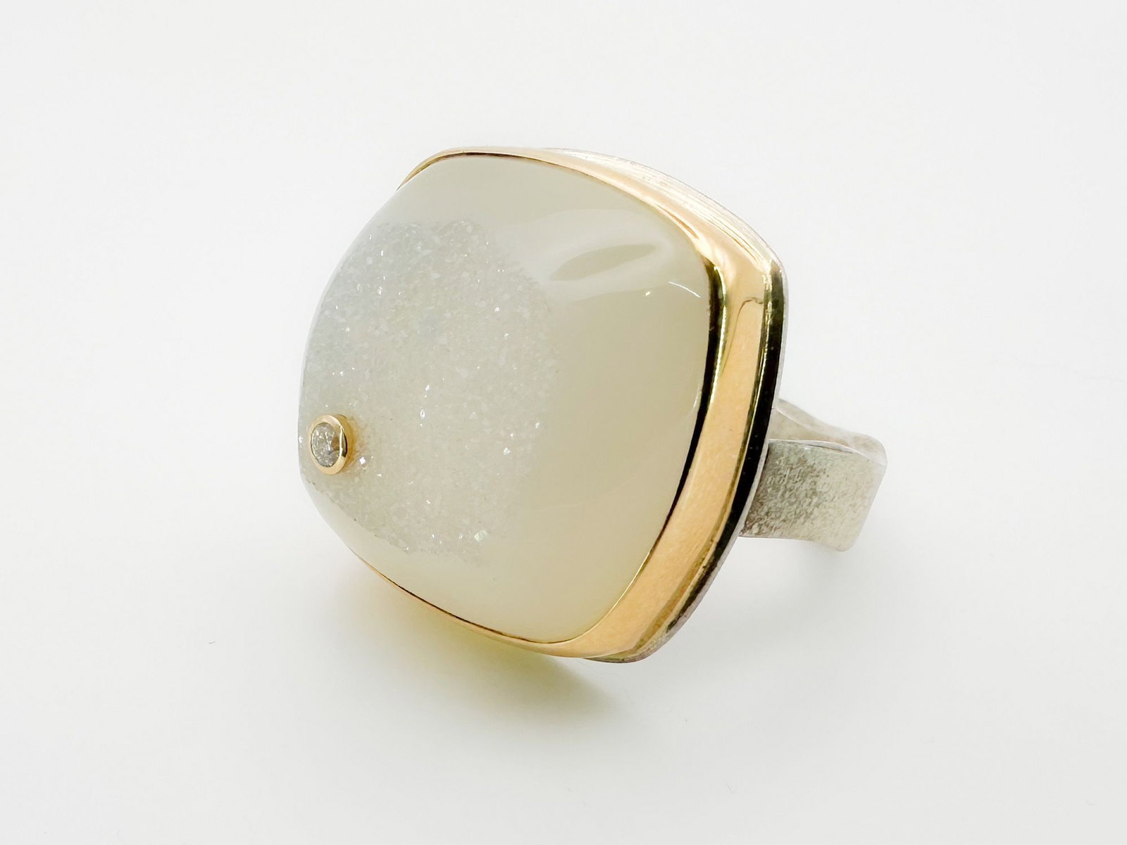 Jamie Joseph Drusy & Diamond Ring, 14K Gold Bezel & Sterling Silver Band: Jamie Joseph ring featuring a white drusy stone accented with a diamond, set in 14K gold and sterling silver. Size 9, face measures 3/4 x 3/4 inch. Weighs 15.3 grams. The exposed geode surface reflect