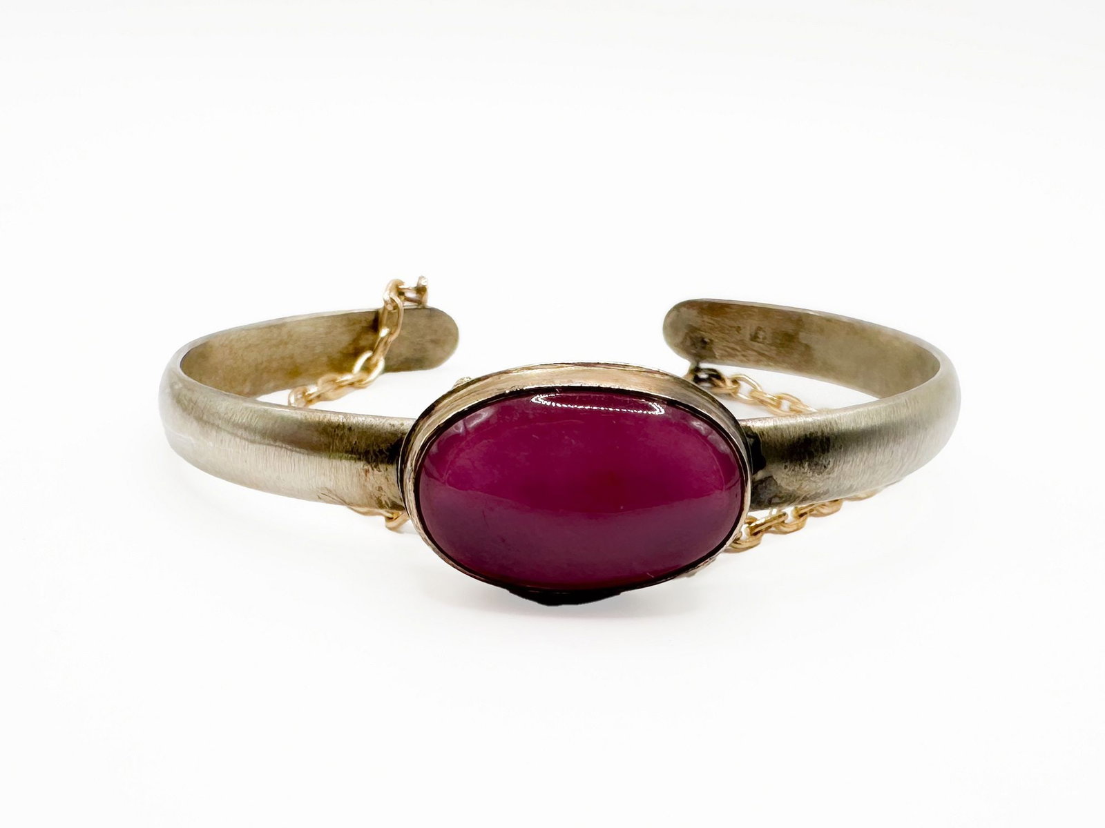 Jamie Joseph Ruby, 14K Gold & Sterling Silver Cuff Bracelet: Jamie Joseph cuff bracelet featuring a ruby cabochon set in a 14K gold bezel with gold chains. The cuff is sterling silver, measures 5.5 inches, and has a 6-inch opening. Weighs 21.2 grams.