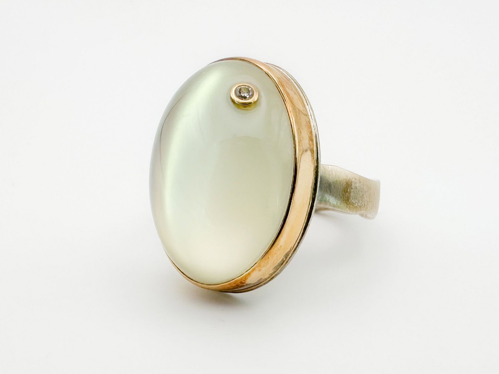 Jamie Joseph Moonstone & Diamond, 14K Gold Bezel & Sterling Silver Band: Jamie Joseph ring featuring a moonstone cabochon with a diamond accent, set in 14K gold and sterling silver. Size 8. Face measures 1 x 5/8 inches. Weighs 13.2 grams.