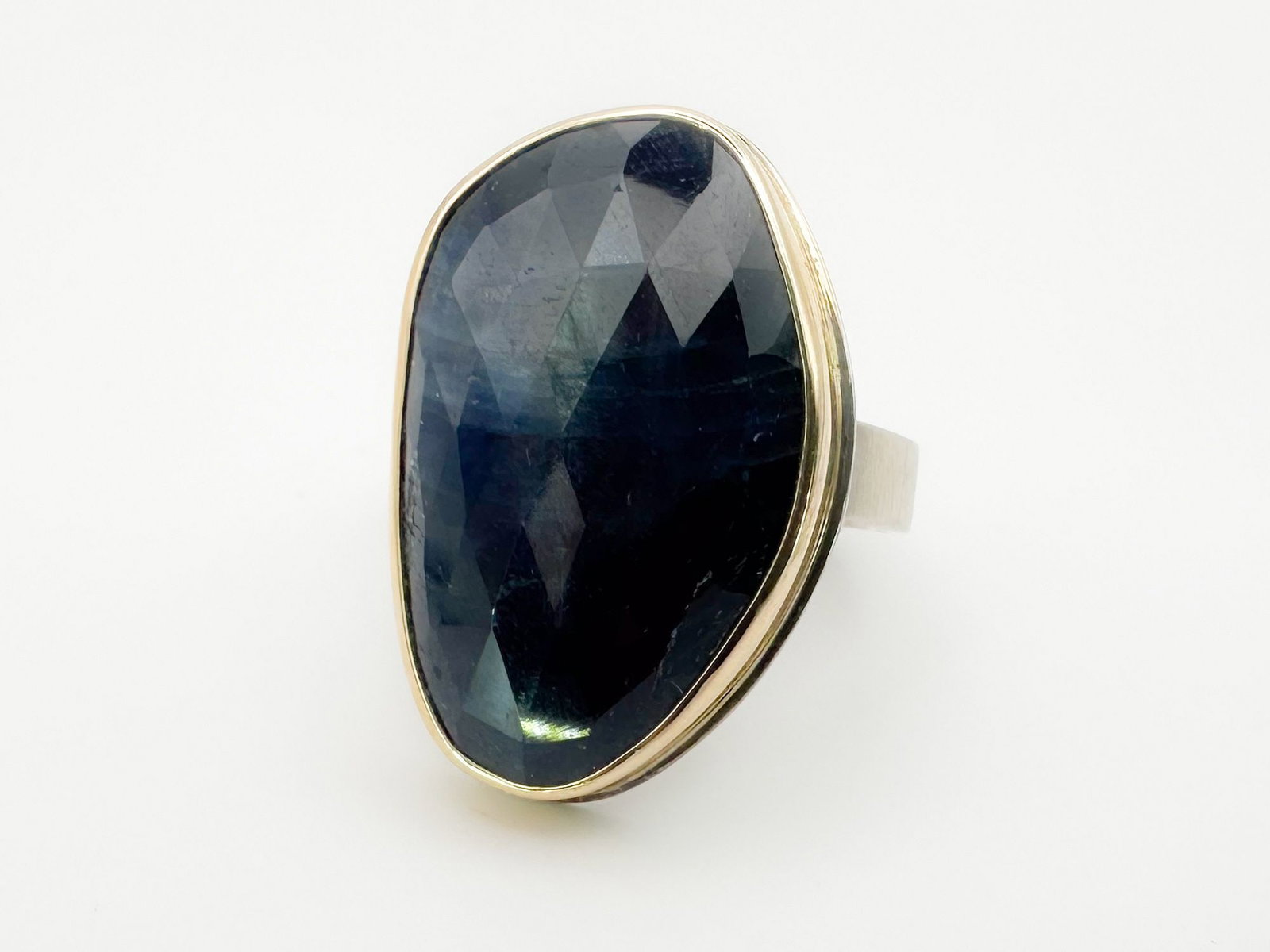Jamie Joseph Tanzanite, 14K Gold Bezel & Sterling Silver Band: Jamie Joseph ring featuring a faceted Tanzanite set in 14K gold bezel with a sterling silver band. Size 9. Face measures 1 1/8 x 3/4 inches. Weighs 17.5 grams.