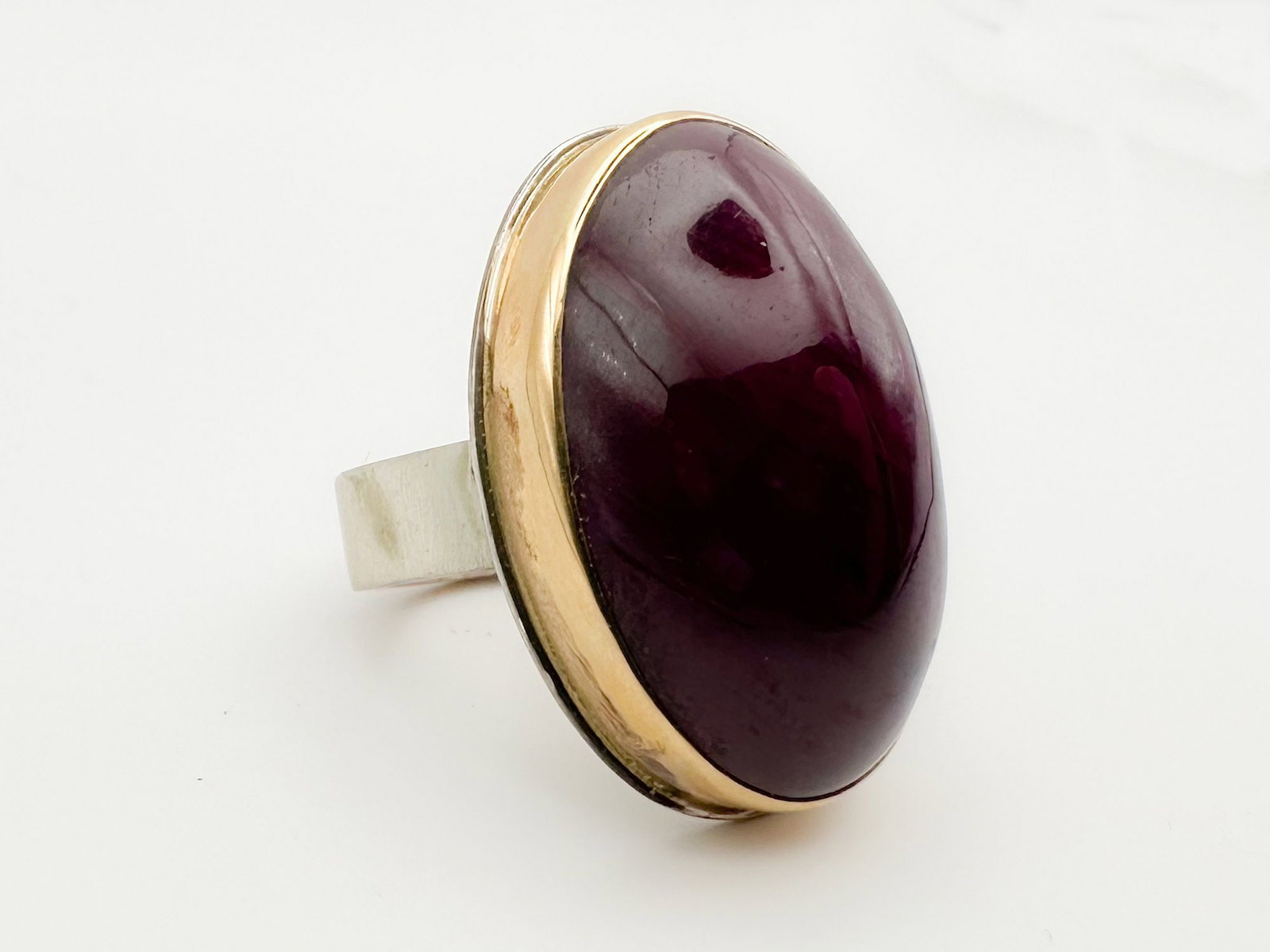 Jamie Joseph Ruby Ring, 14K Gold Bezel & Sterling Silver Band: Jamie Joseph ring featuring a smooth, oval ruby cabochon set in 14K gold and sterling silver. Size 8. Face measures 1.5 x 0.75 inches. Weighs 24 grams.