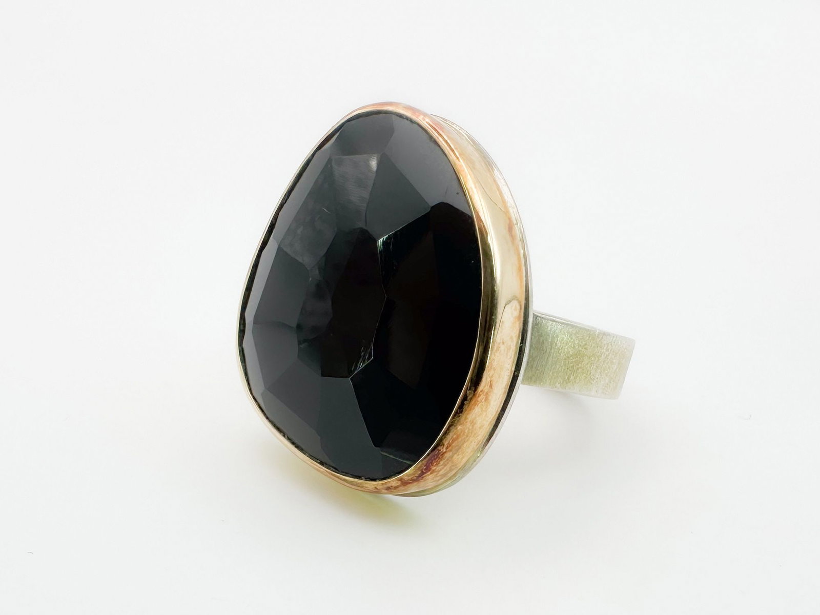 Jamie Joseph Onyx Ring, 14K Gold Bezel & Sterling Silver Band: Jamie Joseph ring featuring a faceted onyx stone set in 14K gold and sterling silver. Size 8. The face of the ring measures 1 x 3/4 inch. Total weight: 12.2 grams.