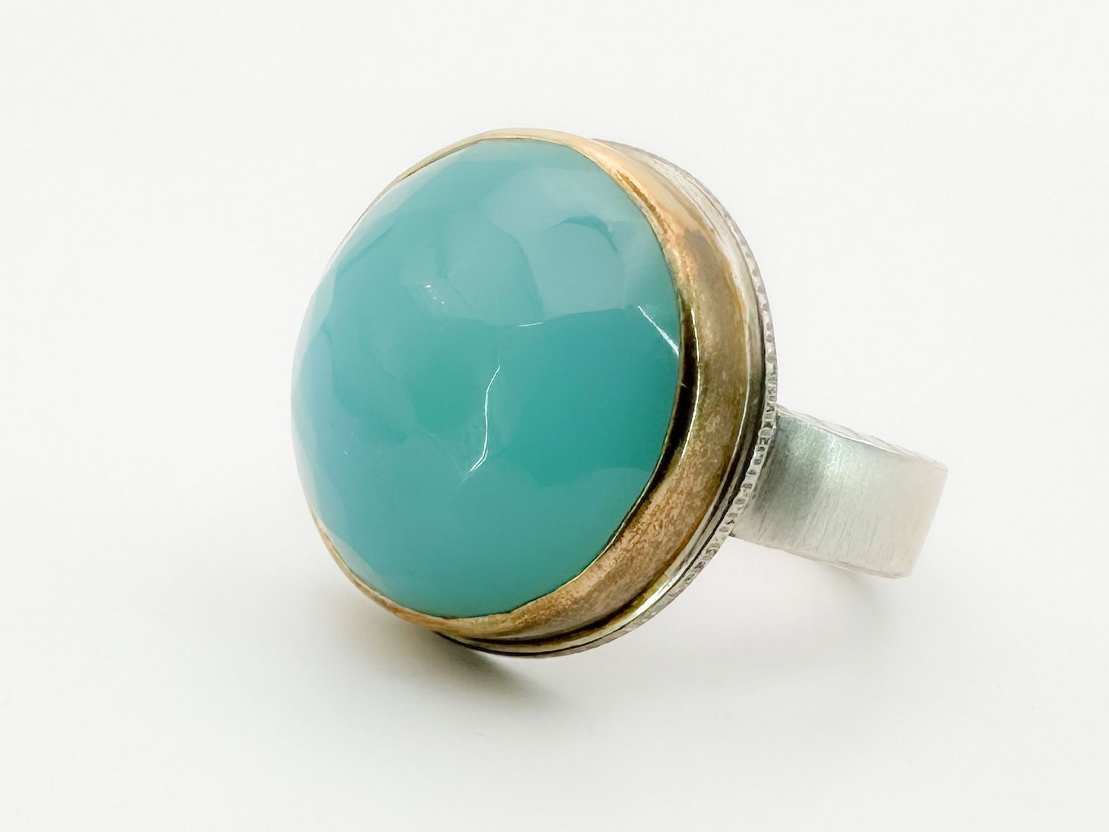 Jamie Joseph Sea Blue Chalcedony Ring, 14K Gold Bezel & Sterling Silver Band: Jamie Joseph ring featuring a faceted sea blue chalcedony stone set in 14K gold and sterling silver. Size 10.5. Face diameter approximately 3/4 inch. Weighs 15.9 grams.