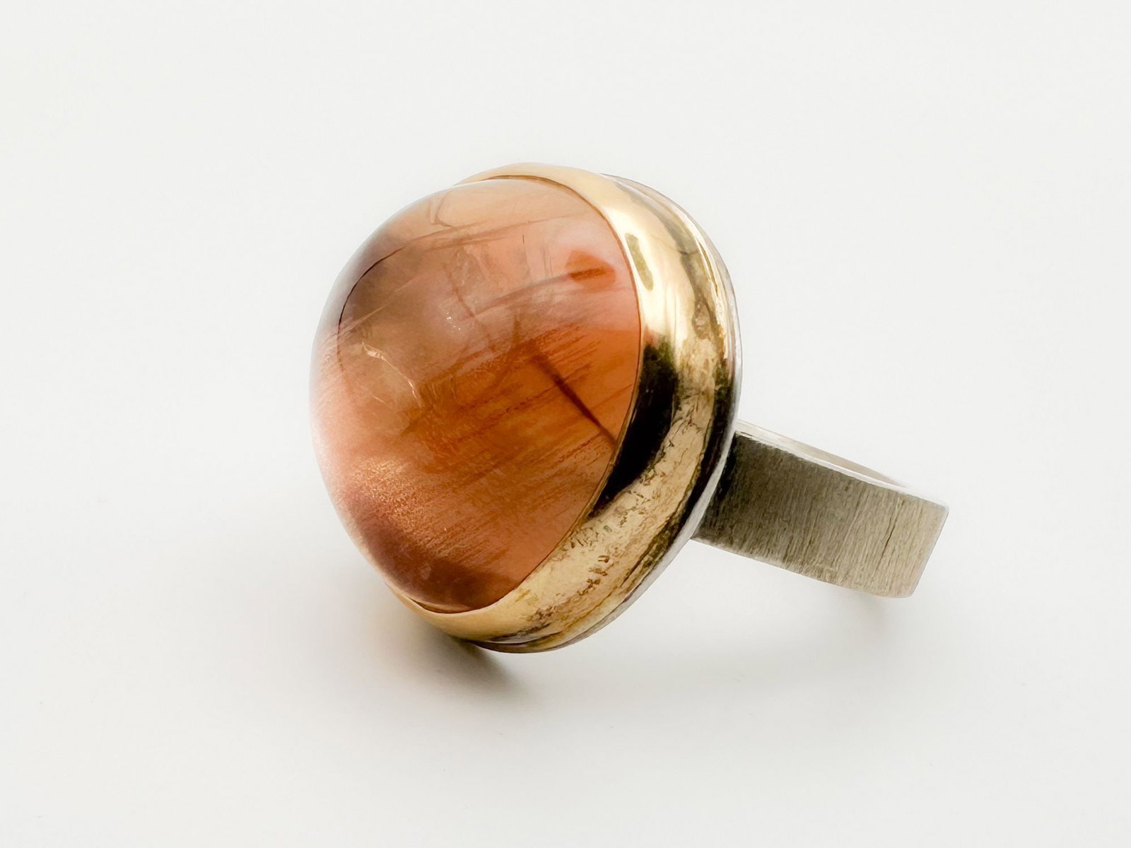Jamie Joseph Moonstone Ring, 14K Gold Bezel & Sterling Silver Band: Jamie Joseph ring featuring a large, round moonstone cabochon set in 14K gold bezel with a sterling silver band. Size 8. Face measures 3/4 x 3/4 inches. Weighs 14.5 grams.