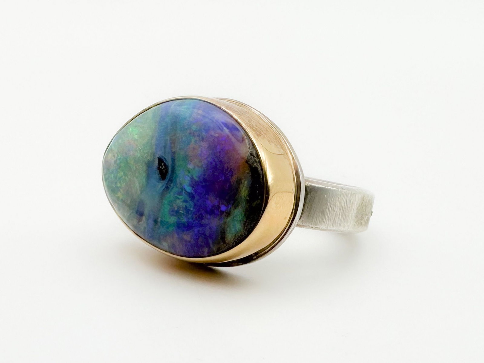 Jamie Joseph Boulder Opal Ring, 14K Gold Bezel & Sterling Silver Band: Jamie Joseph ring featuring a vibrant opal set in 14K gold and sterling silver. Size 6. The face of the ring measures approximately 3/4 x 1/2 inch. Total weight: 8.9 grams.