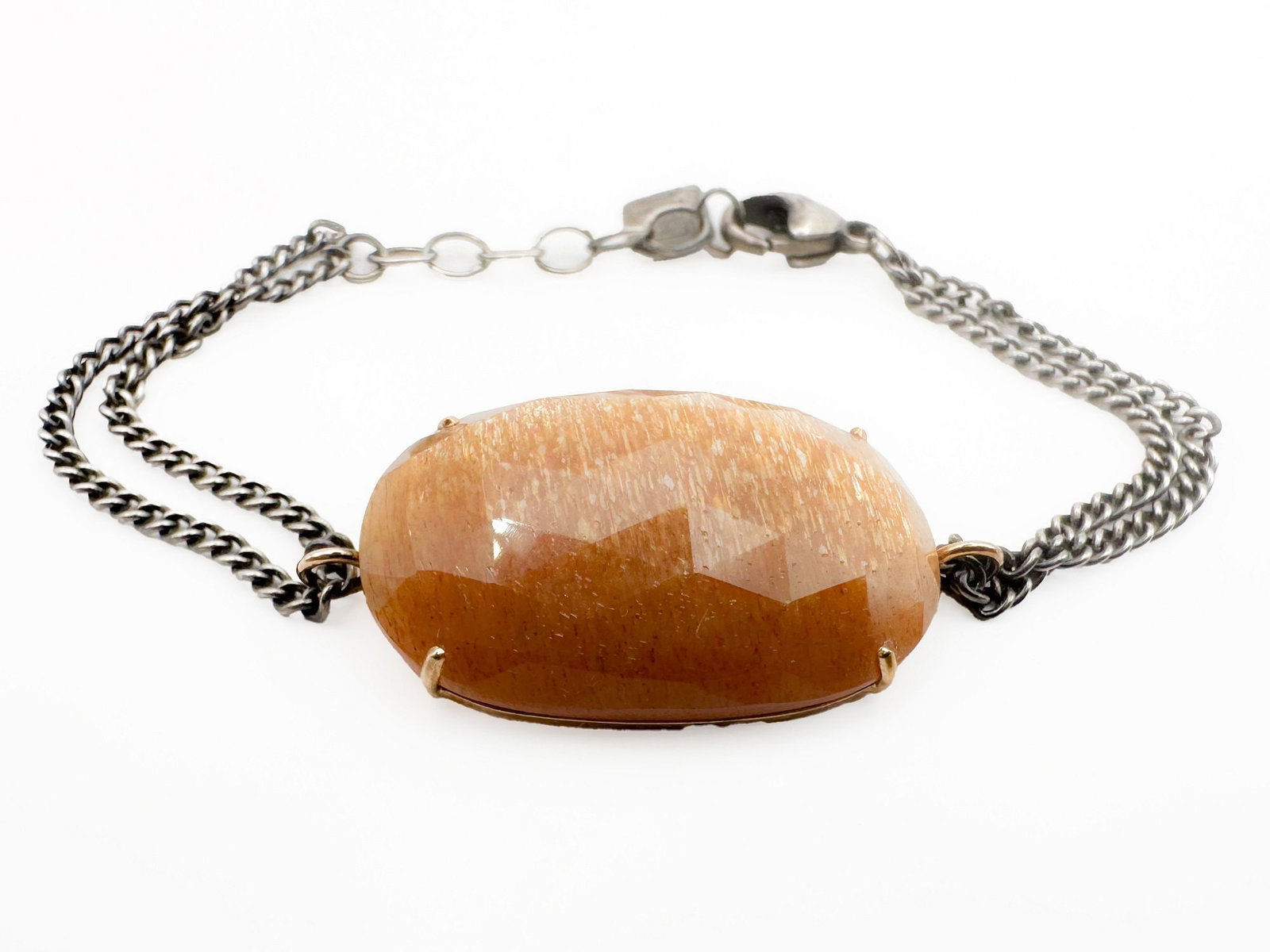 Jamie Joseph Rutilated Quartz Bracelet, 14K & Sterling: Jamie Joseph bracelet featuring a rutilated quartz in a 14K gold bezel setting and sterling silver link chain. Measures 6 3/4 inches long, with the quartz measuring 1 1/4 x 3/4 inches. Weighs 9.2 gram