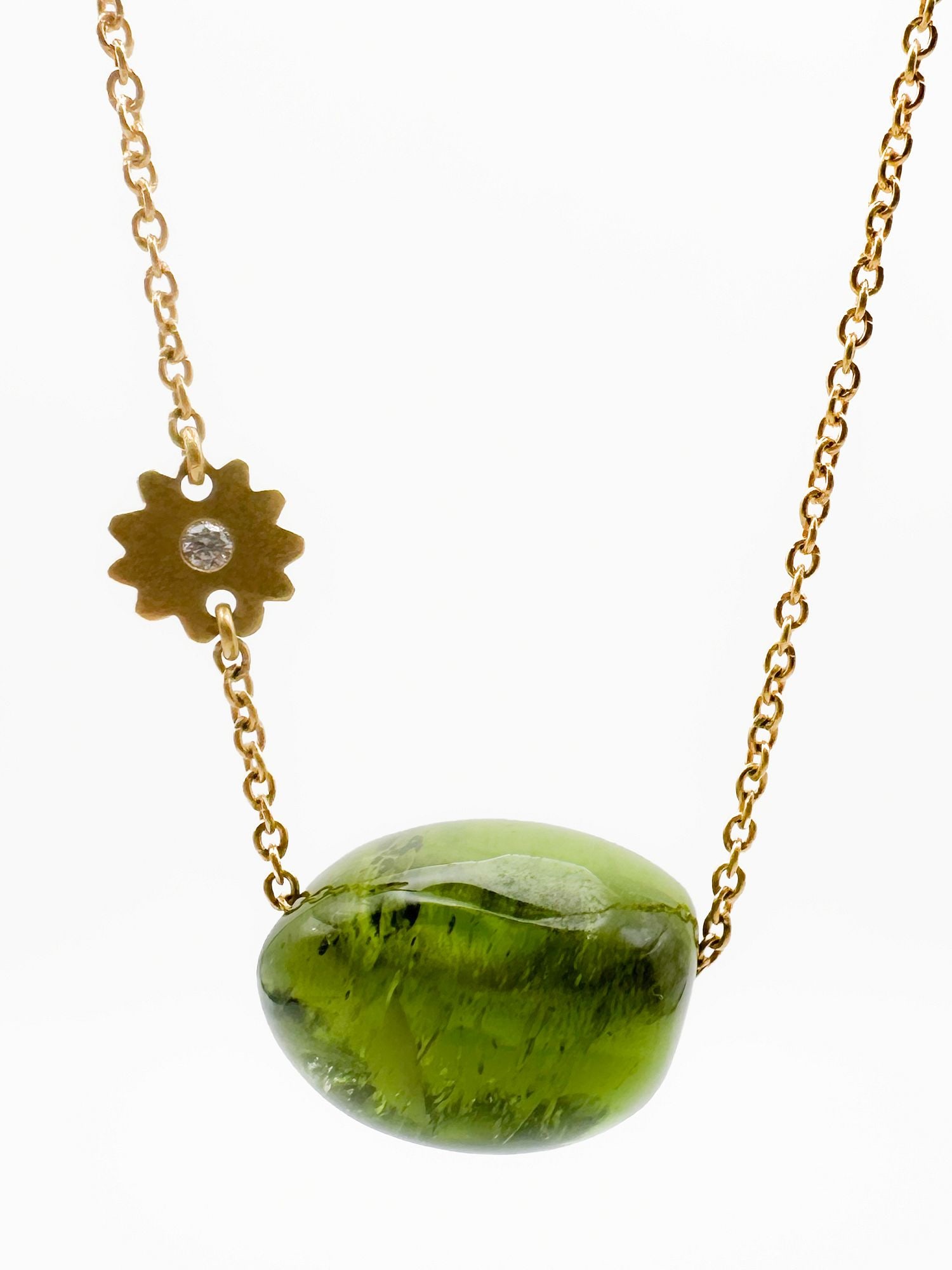 24K Gold, Green Tourmaline & Diamond Pendant Necklace: 24K yellow gold necklace featuring a green tourmaline pendant and a diamond-set flower accent. Necklace is 20 inches long, pendant gemstone is 1 inch. Total weight: 24.1 grams.