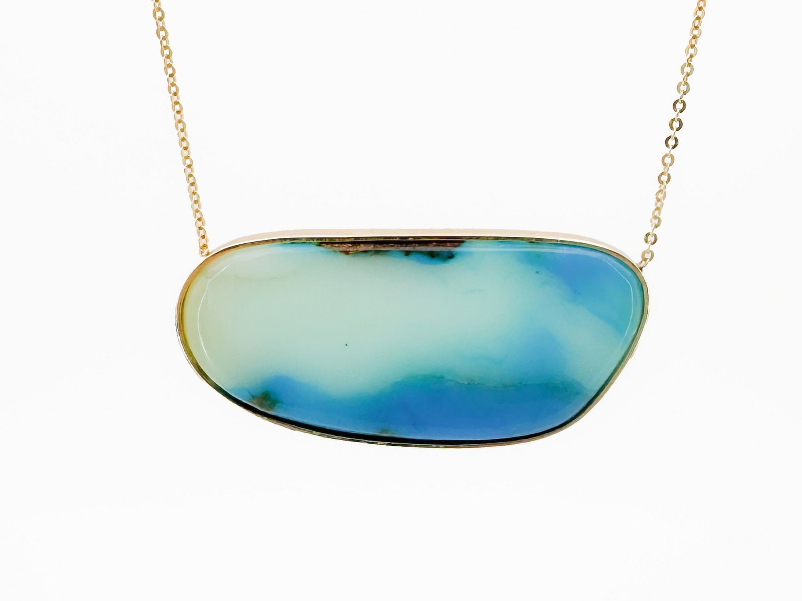 18K Gold Boulder Opal Pendant Necklace: 18K yellow gold necklace featuring a boulder opal pendant. Hallmarked AM. Chain is 16 inches, pendant is 1 5/8 inches wide. Weighs 9.2 grams.