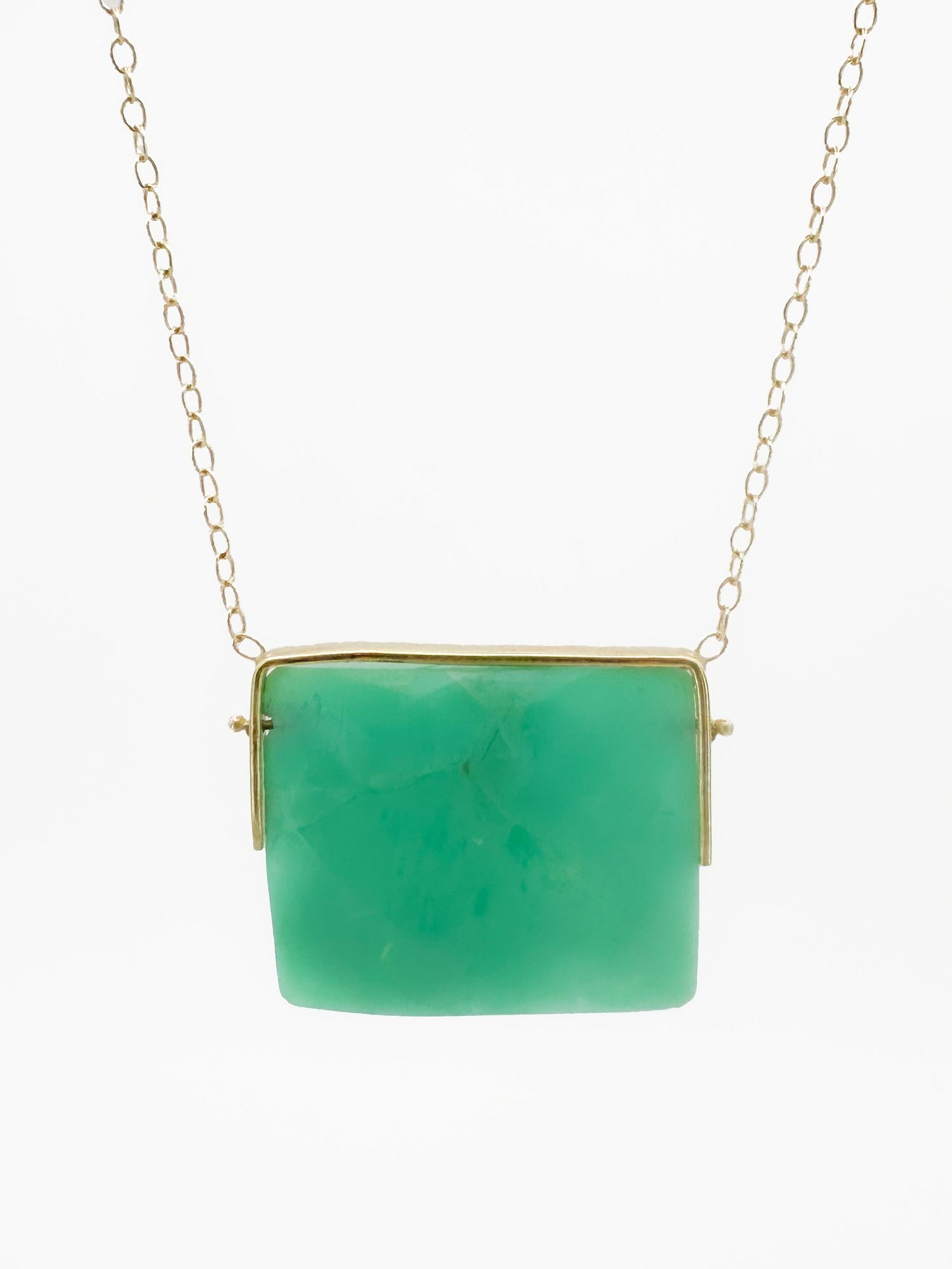 14K Gold & Chrysoprase Pendant Necklace: 14K yellow gold necklace featuring a faceted chrysoprase pendant. Chain is 16 inches long. Pendant measures 1 1/8 inches wide. Total weight: 8.4 grams.