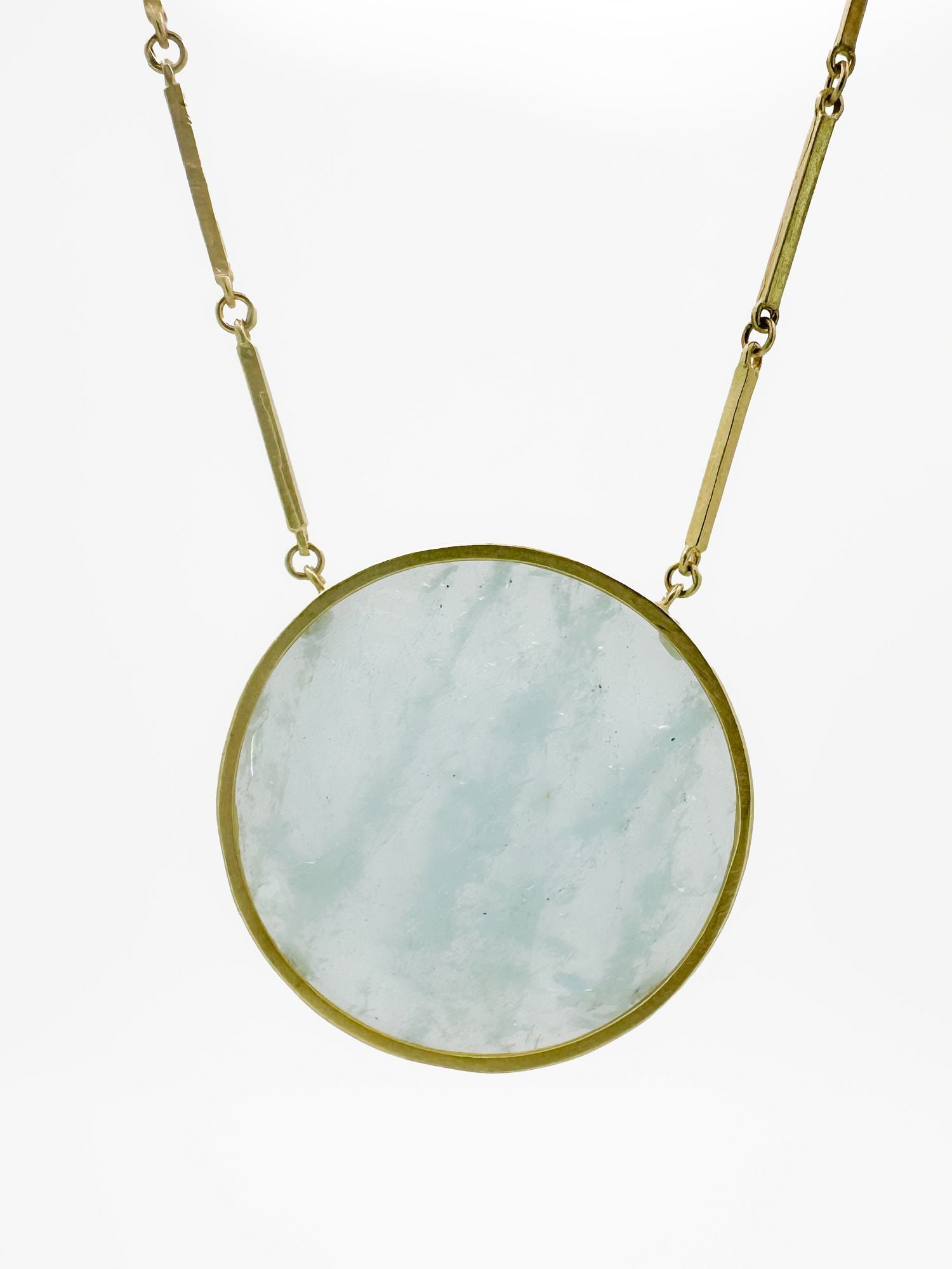 18K Gold Aquamarine Pendant Necklace: 18K gold necklace featuring a large, round, faceted pale blue aquamarine pendant. The chain is 17 inches long, and the pendant is 1 1/2 inches in diameter. Total weight: 23.2 grams.