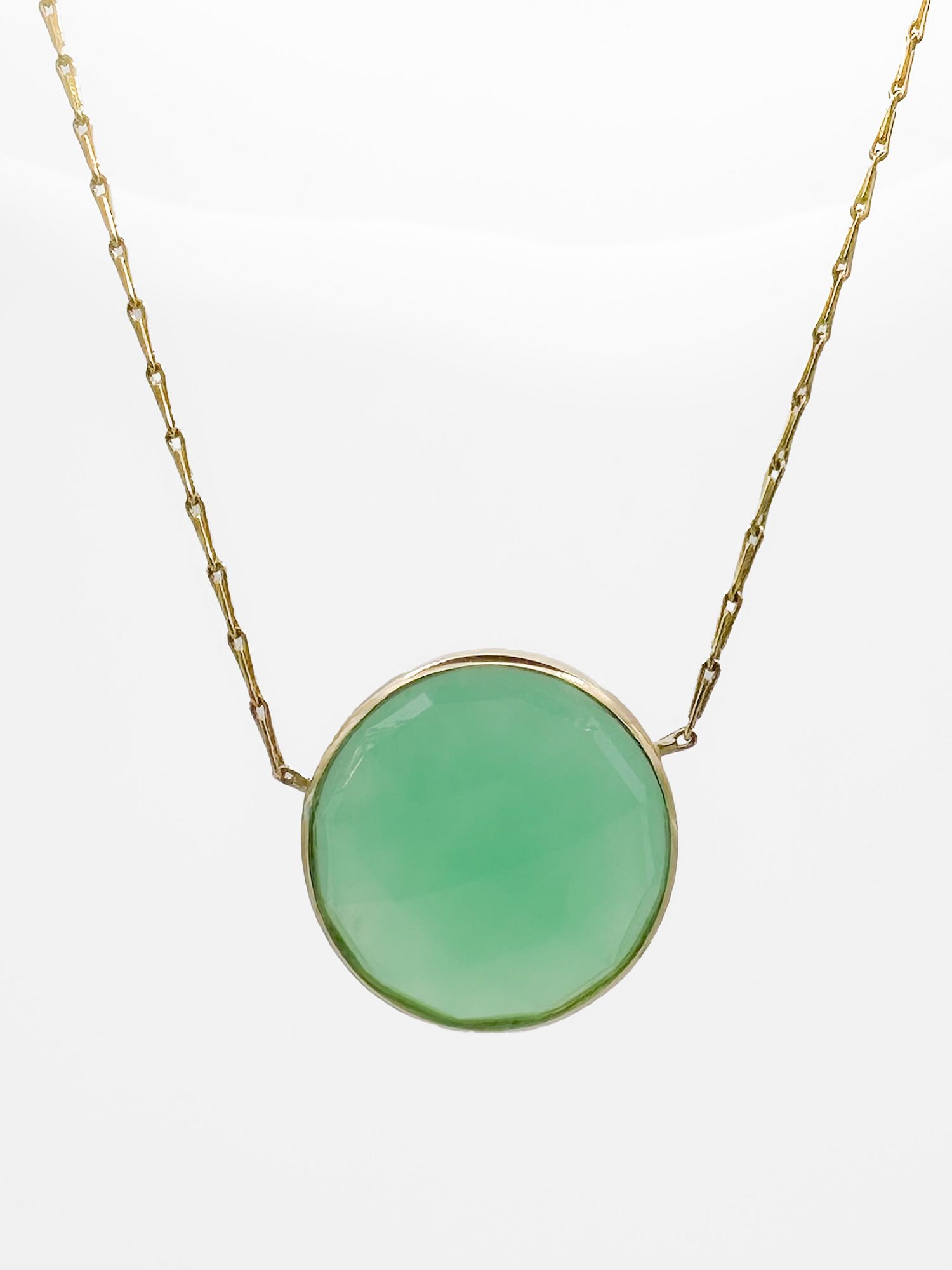 14K Gold Chrysoprase Pendant Necklace, Italy: 14K yellow gold necklace featuring a faceted chrysoprase pendant. Marked Italy. 19 inches long, pendant 3/4 inch diameter. Weighs 5.9 grams.