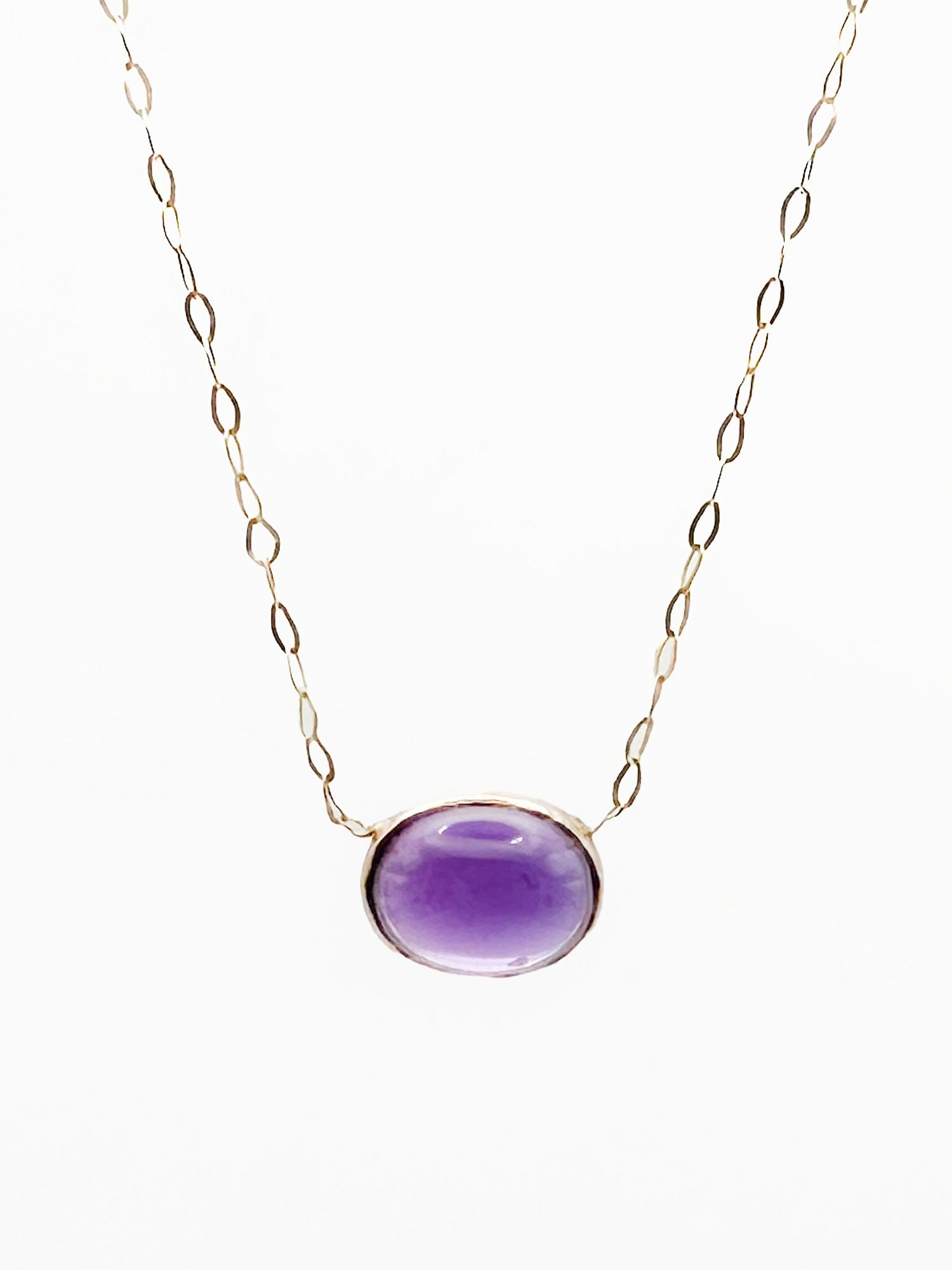 14K Gold Amethyst Cabochon Pendant Necklace, Italy: 14K yellow gold necklace featuring an oval cabochon amethyst pendant. Marked Italy. 16 inches long, pendant is 3/8 inch. Weighs 1 gram.