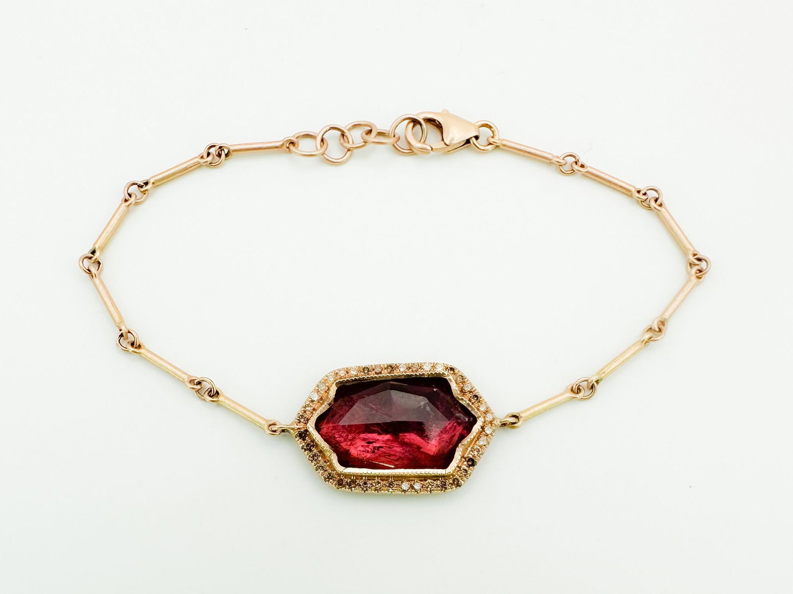 Brooke Gregson 14K Rose Gold Tourmaline Diamond Bracelet: Brooke Gregson bracelet featuring a central tourmaline with a diamond bezel, set in 14K rose gold. 6.5 inches long, center stone is 7/8 inch long. 5.4 grams.