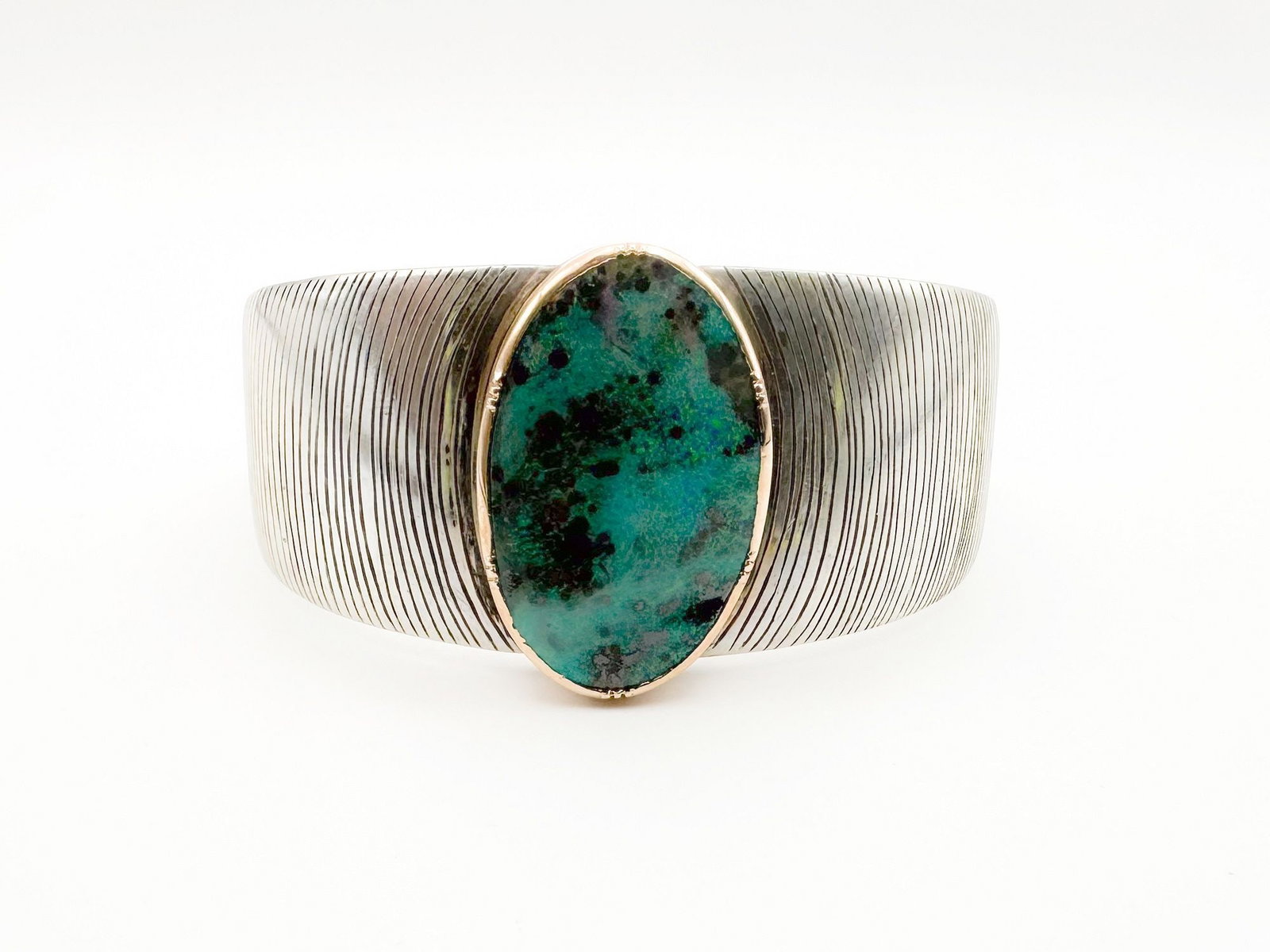 Brooke Gregson Sterling & 18K Gold Boulder Opal Cuff: Brooke Gregson cuff bracelet featuring a sterling silver band with textured lines and an 18K gold bezel set boulder opal. Measures 4 3/4 inches wide with a 6 inch circumference. Weighs 57.4 grams.