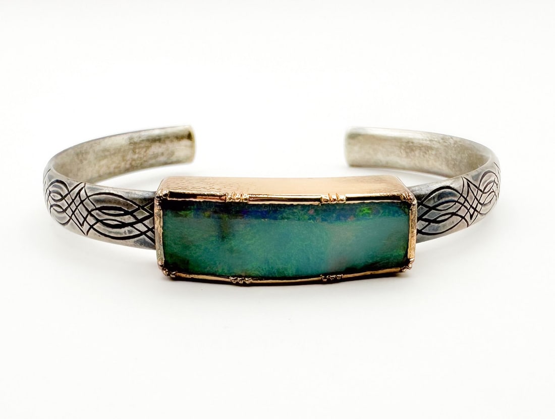 Brooke Gregson Opal, Sterling & 18K Gold Cuff Bracelet: Brooke Gregson cuff bracelet featuring a boulder opal in an 18K gold bezel, set on a sterling silver band with etched design. 5 inch cuff, 6 inch bracelet. 20.6 grams.