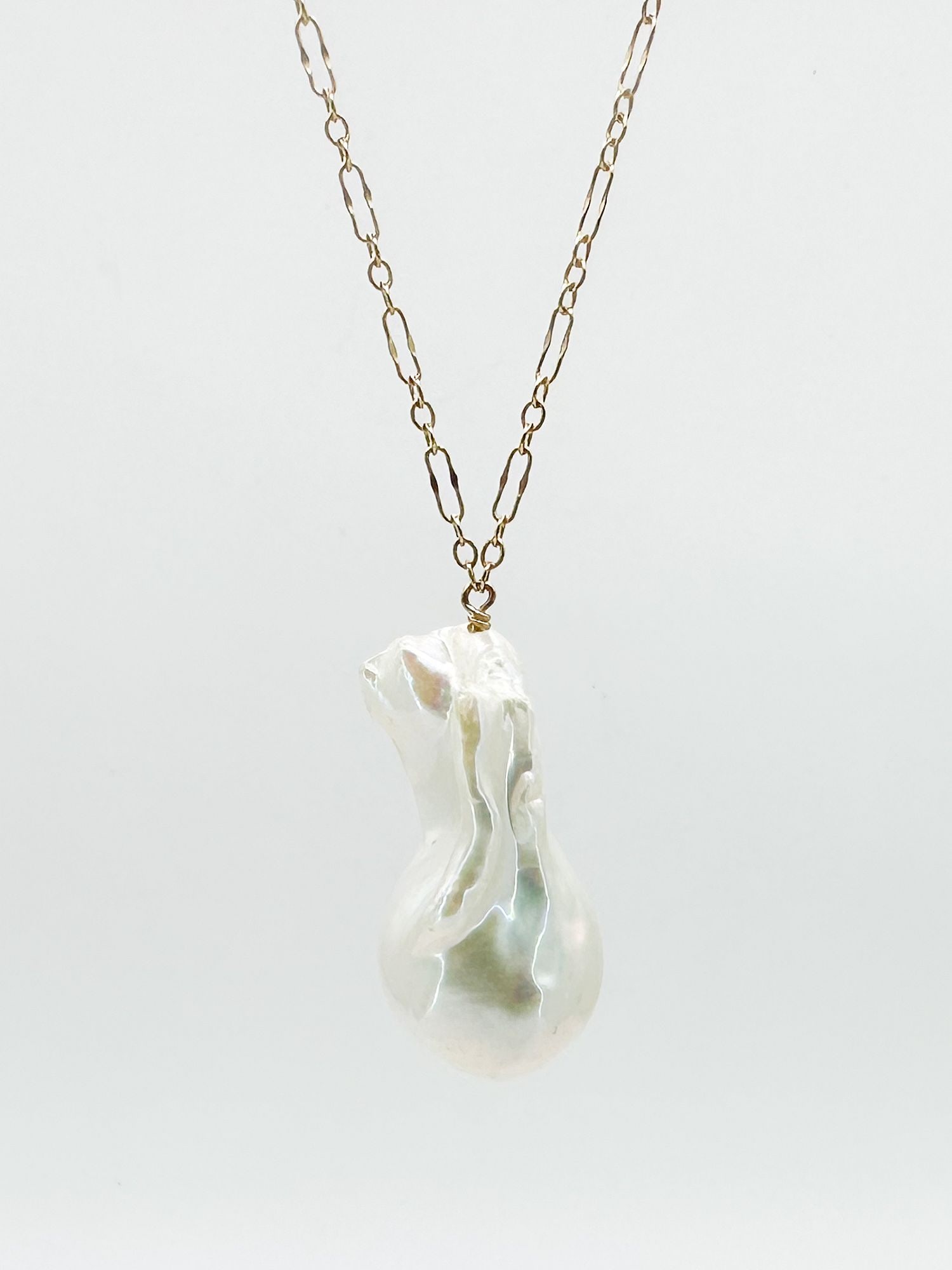 14K Gold Baroque Pearl Pendant Necklace, 16 inches: 14K yellow gold necklace featuring a baroque pearl pendant. Necklace is 16 inches long. Pearl measures 1 1/8 inch long. Total weight: 8.2 grams.