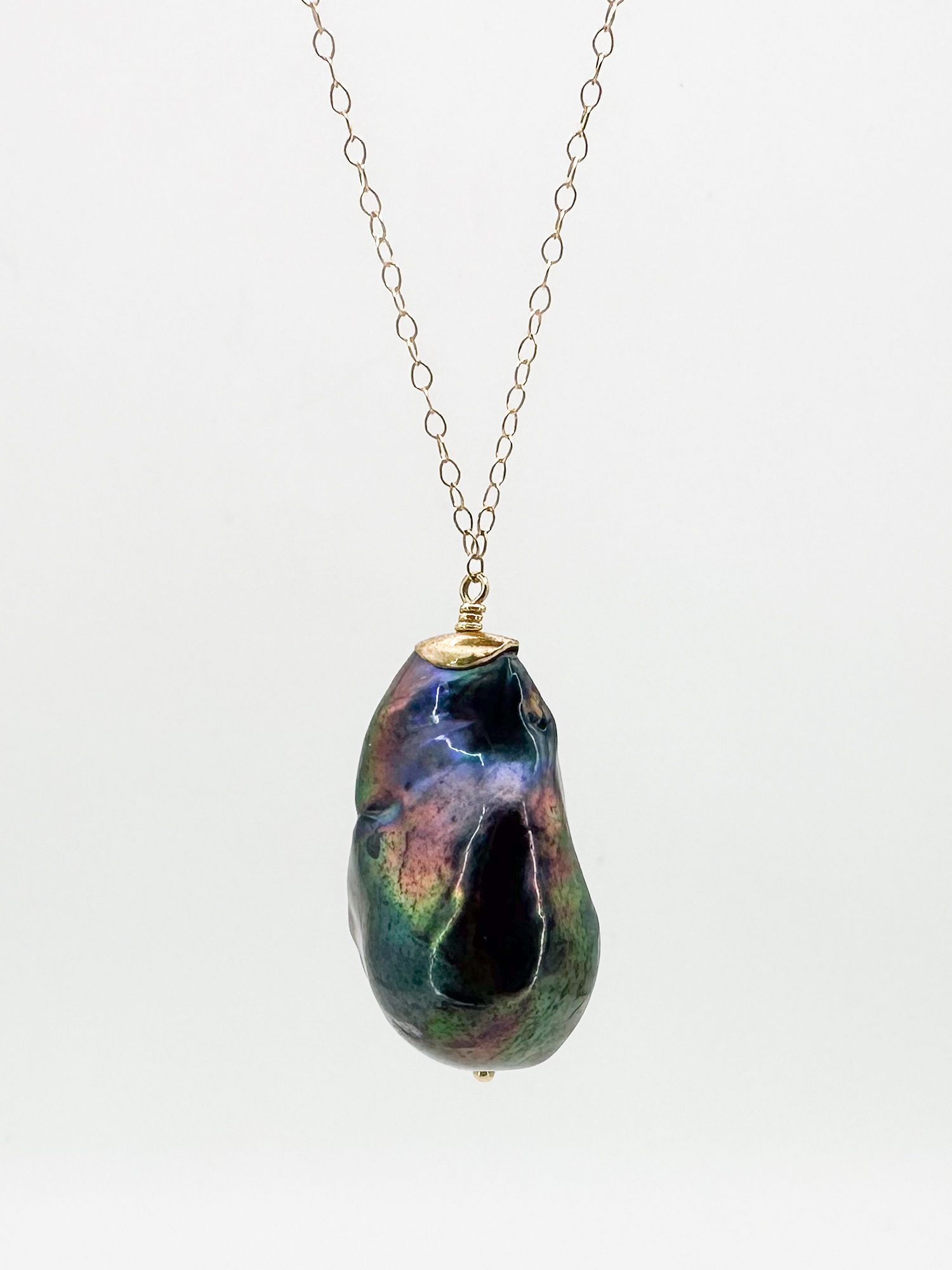 14K Gold & Tahitian Pearl Pendant Necklace: 14K gold chain necklace featuring a large, baroque Tahitian pearl pendant. Chain is 17 inches long, pearl is 1 1/8 inches long. Total weight: 9 grams.