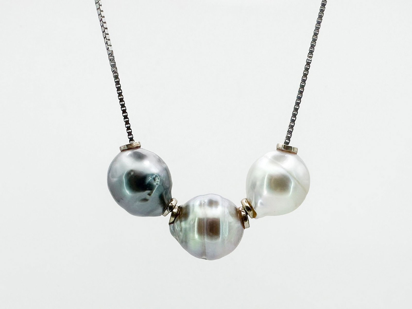 14K White Gold Tahitian Pearl Pendant Necklace: 14K white gold necklace featuring a trio of Tahitian pearls. The chain is 16 inches long, and the pearl cluster is 1.5 inches. Weighs 7.2 grams.