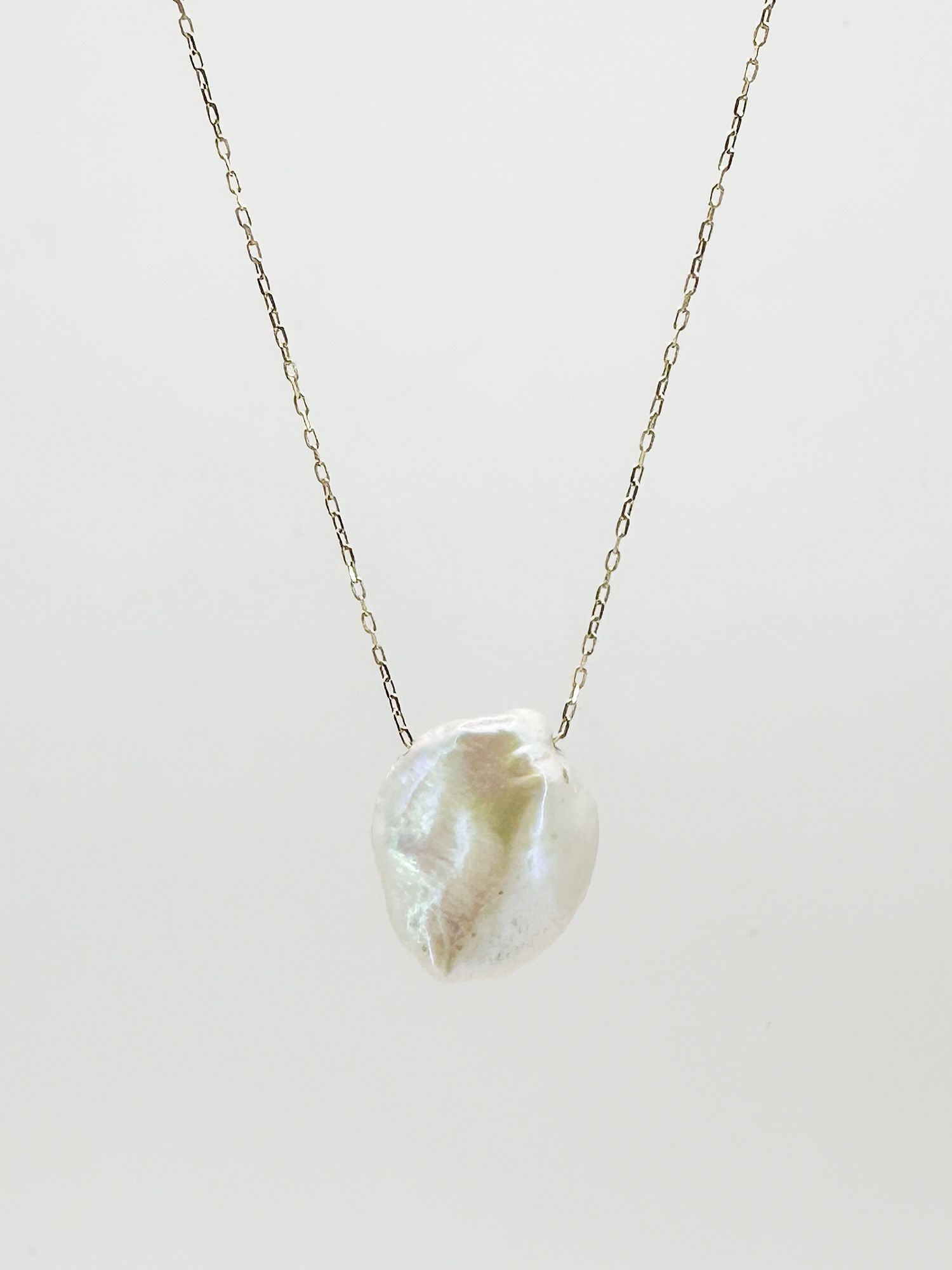 14K Yellow Gold Pearl Pendant Necklace: 14K yellow gold necklace featuring a baroque pearl pendant. The necklace is 16 inches long, and the pearl measures approximately 3/8 inch in diameter. Total weight: 1.1 grams.