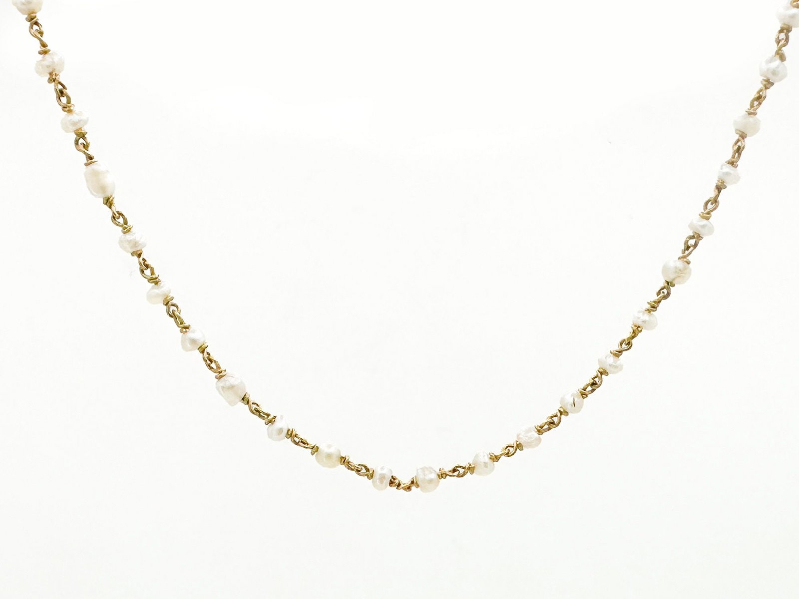 14K Gold & Pearl Choker Necklace: 14K yellow gold choker necklace featuring small pearls. Measures approximately 16 inches in length and weighs 3 grams.