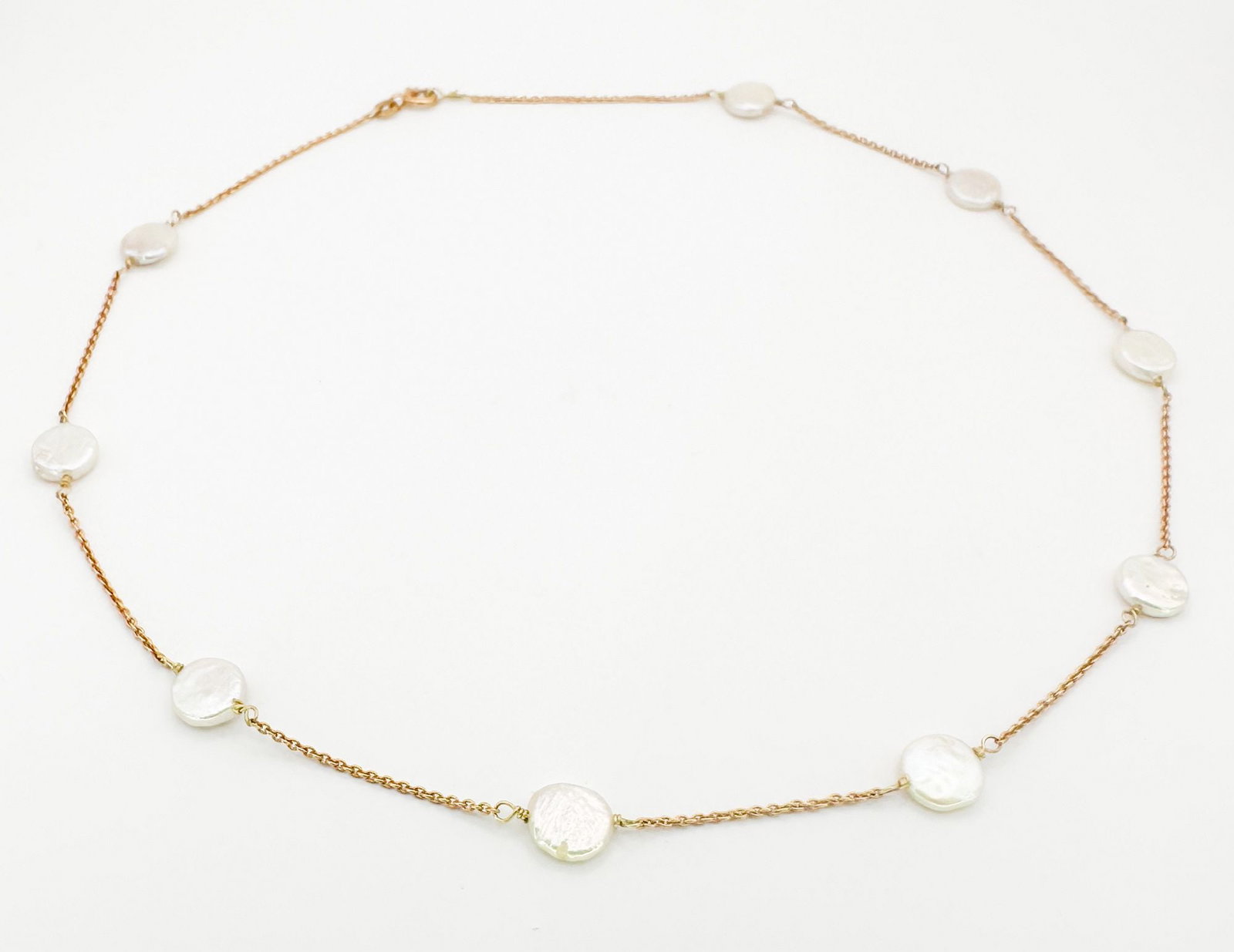 14K Gold & Freshwater Pearl Disc Necklace: A 14K gold necklace featuring freshwater pearl discs. The necklace is 17 1/2 inches long and weighs 5 grams.
