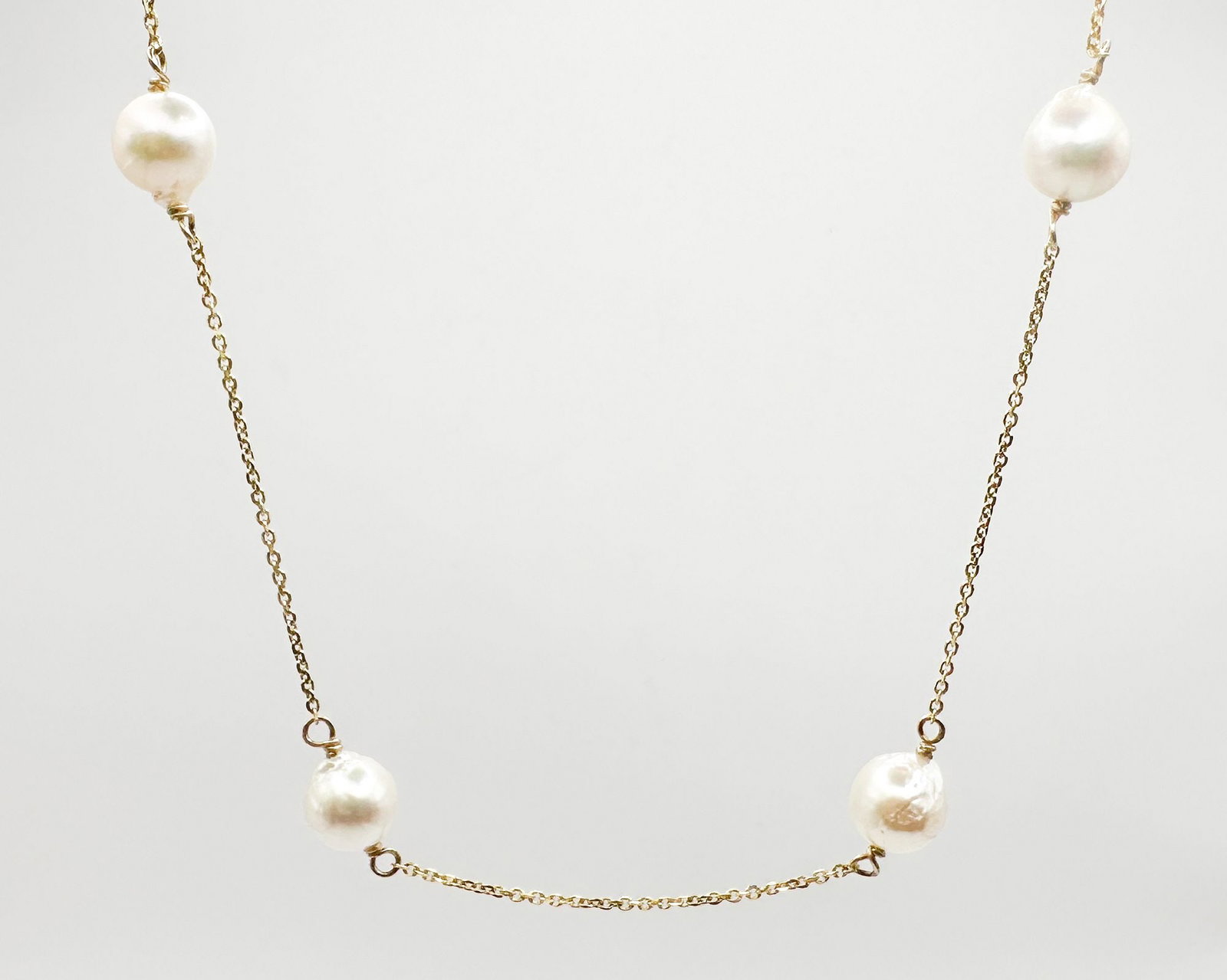 14K Gold Link Chain and Pearl Necklace, 18 Inches: 14K yellow gold necklace featuring a delicate link chain interspersed with four baroque pearls. Measures 18 inches in length and weighs 6.8 grams.