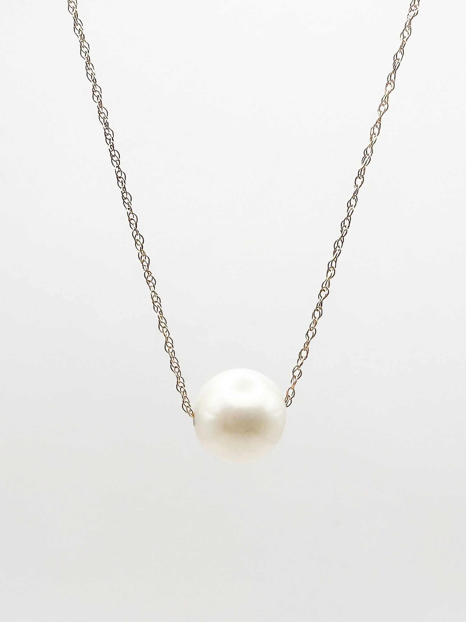 14K Yellow Gold Pearl Pendant Necklace: 14K yellow gold necklace featuring a pearl pendant. The necklace is 16 inches long and weighs 1.9 grams.