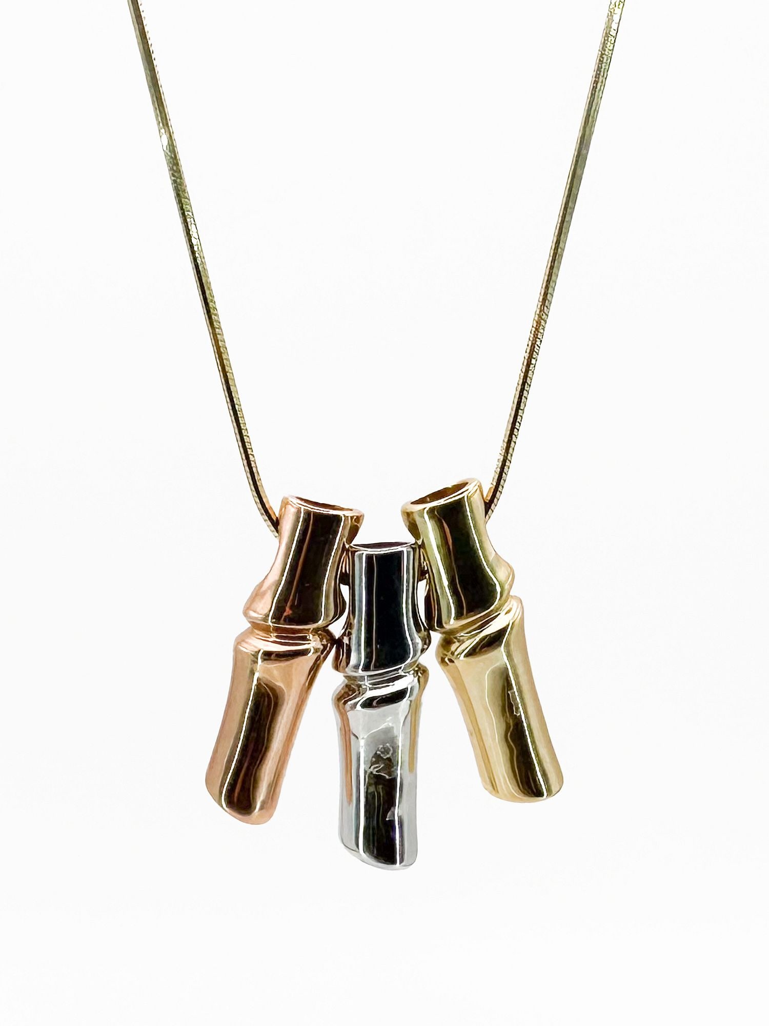 14K Tri-Color Gold Bamboo Pendant Necklace: 14K yellow, rose, and white gold bamboo pendant on a snake chain necklace. Pendant is 1 inch long. Chain is 18 inches. Weighs 14.4 grams.