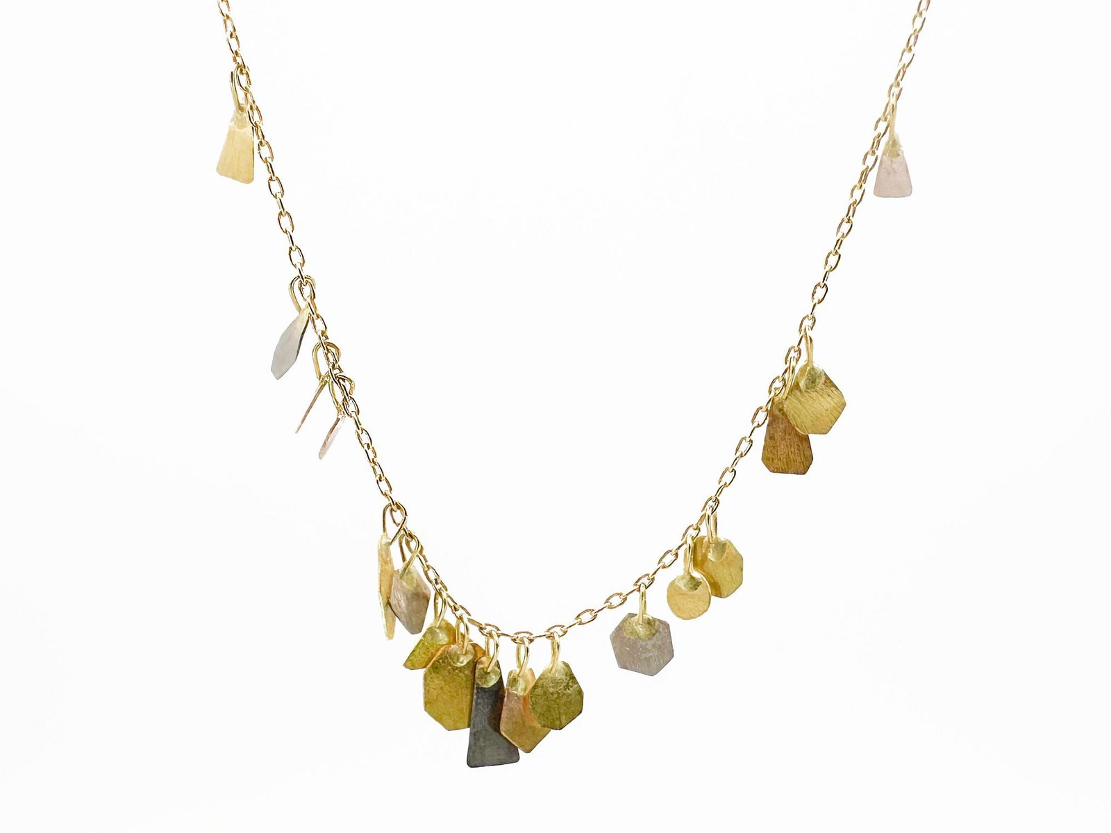 18K Gold Multi Color Leaf Dangle Necklace: 18K gold necklace featuring multi-tone leaf-shaped dangles. Measures 17 inches in length and weighs 1.8 grams.