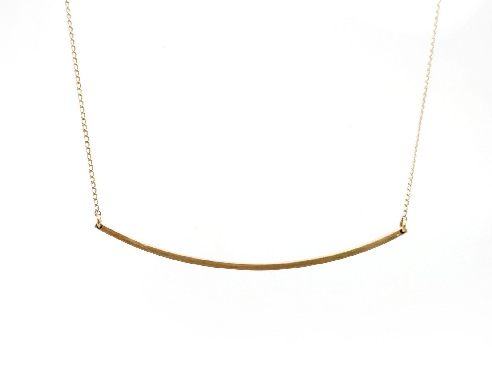 14K Gold Bar Pendant and 12K Gold Chain Necklace: This necklace features a 12K gold chain and a 14K gold curved bar pendant. The chain is 17 inches long, and the bar is 2.5 inches long. Total weight: 2.3 grams.