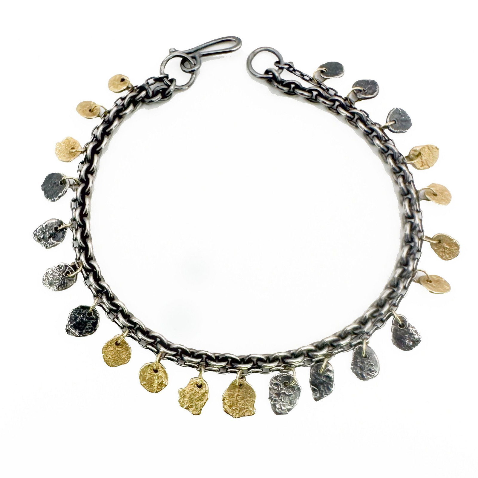 Sarah McGuire 18K Gold & Silver Kelp Pond Bracelet: This Sarah McGuire bracelet features an oxidized sterling silver chain adorned with textured 18K yellow gold discs. The two-tone design creates movement and shimmer. Measures 6 3/4 inches long. W