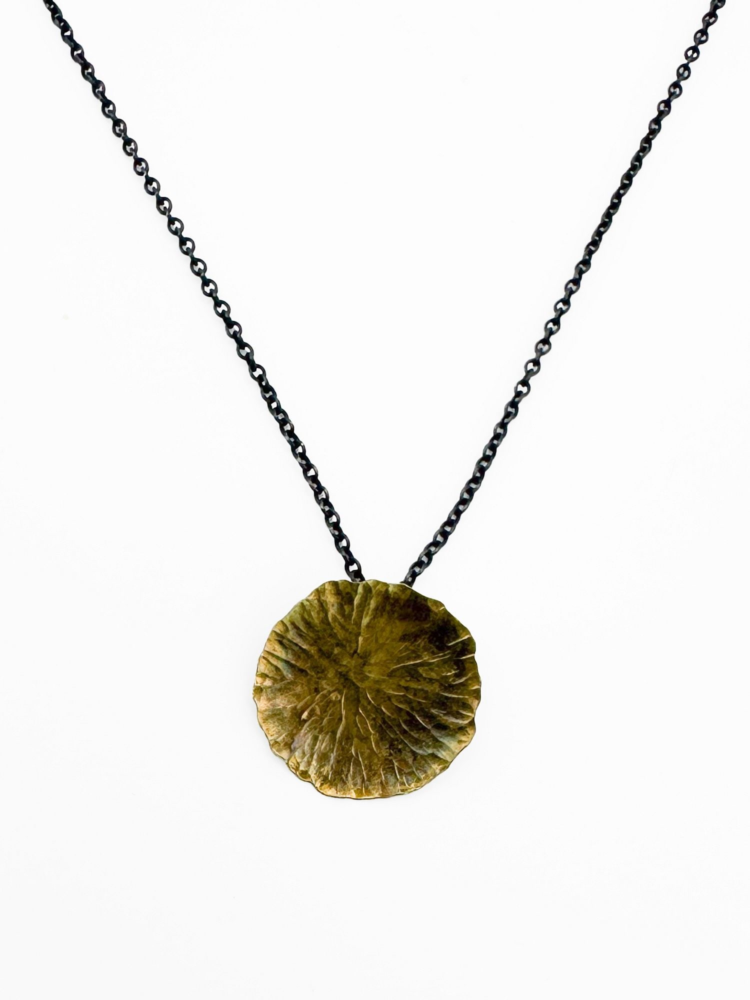 22k Gold Wash Oxidized Silver Pendant Necklace: Round pendant necklace featuring a 22k gold wash over oxidized silver. Chain is 16 inches long. Total weight: 2.6 grams.