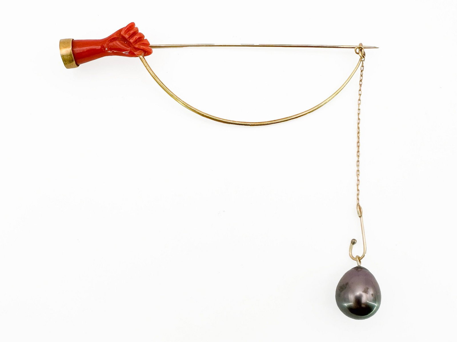 Antique Gold, Coral & Pearl Stick Pin Hand Motif: Antique stick pin featuring a coral hand motif, gold accents, and a pearl drop. Length: 3 inches. Weight: 4.9 grams.