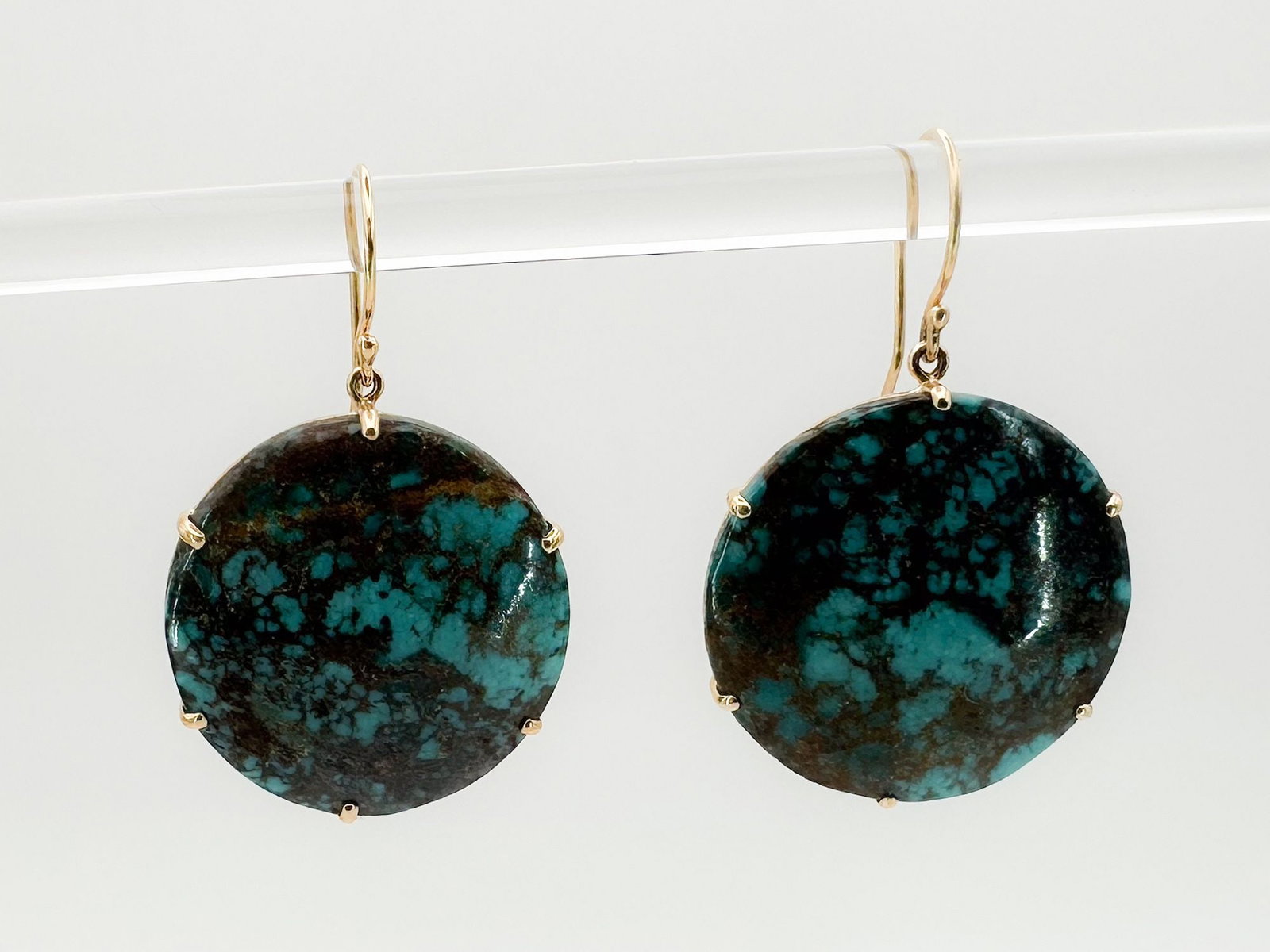 14K Gold & Turquoise Round Drop Earrings: Pair of 14K yellow gold drop earrings featuring round turquoise cabochons. Each earring measures approximately 1 inch in length. Total weight: 7.6 grams.
