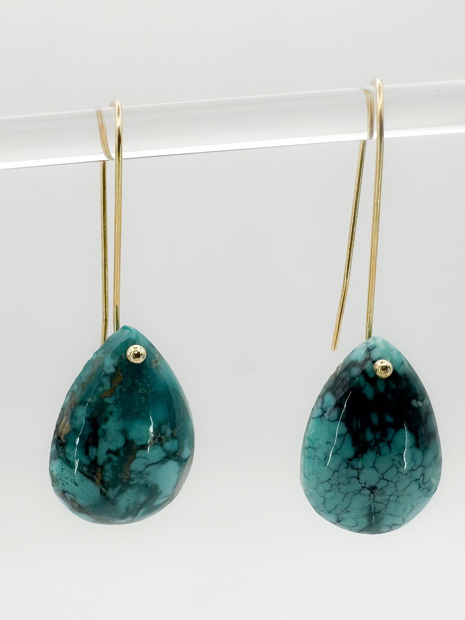 14K Gold & Turquoise Teardrop Dangle Earrings: Pair of 14K yellow gold earrings featuring turquoise teardrop stones. Teardrops measure approximately 0.75 inches in length.