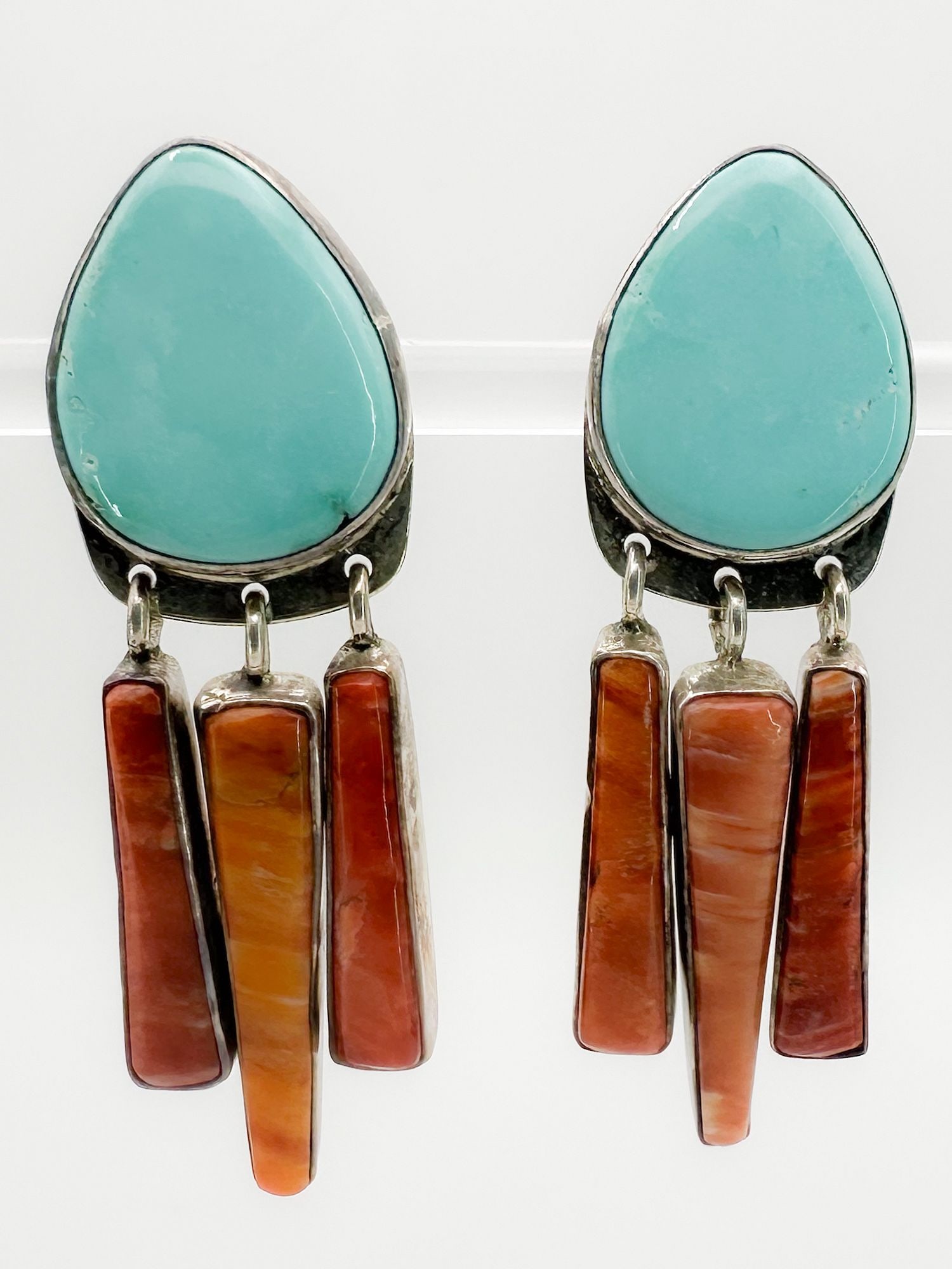 Noah Sterling Turquoise & Coral Drop Earrings: Pair of drop earrings marked 'Noah Sterling'. Features turquoise cabochons and coral drops. Approximately 2 inches long. Total weight: 16.9 grams.