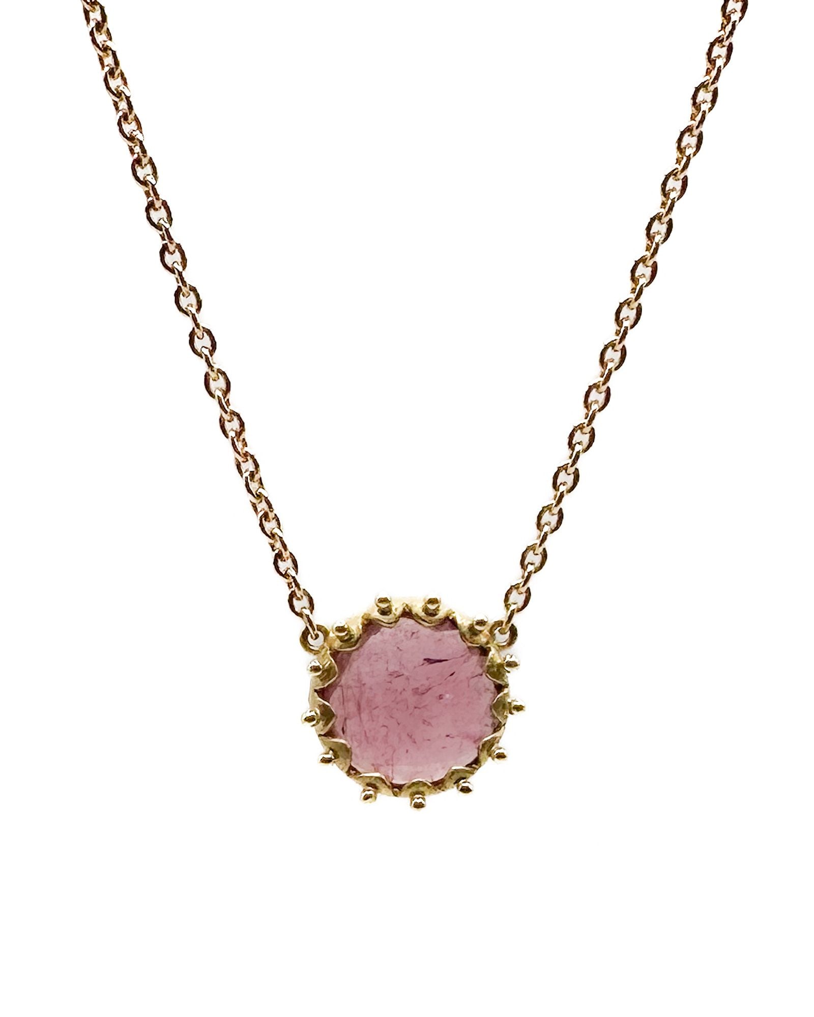18K Yellow Gold Pink Tourmaline Pendant Necklace: 18K yellow gold necklace featuring a round pink tourmaline pendant with beaded edge detail. Marked 18K. Necklace measures 16 inches in length. Total weight: 5.1 grams.