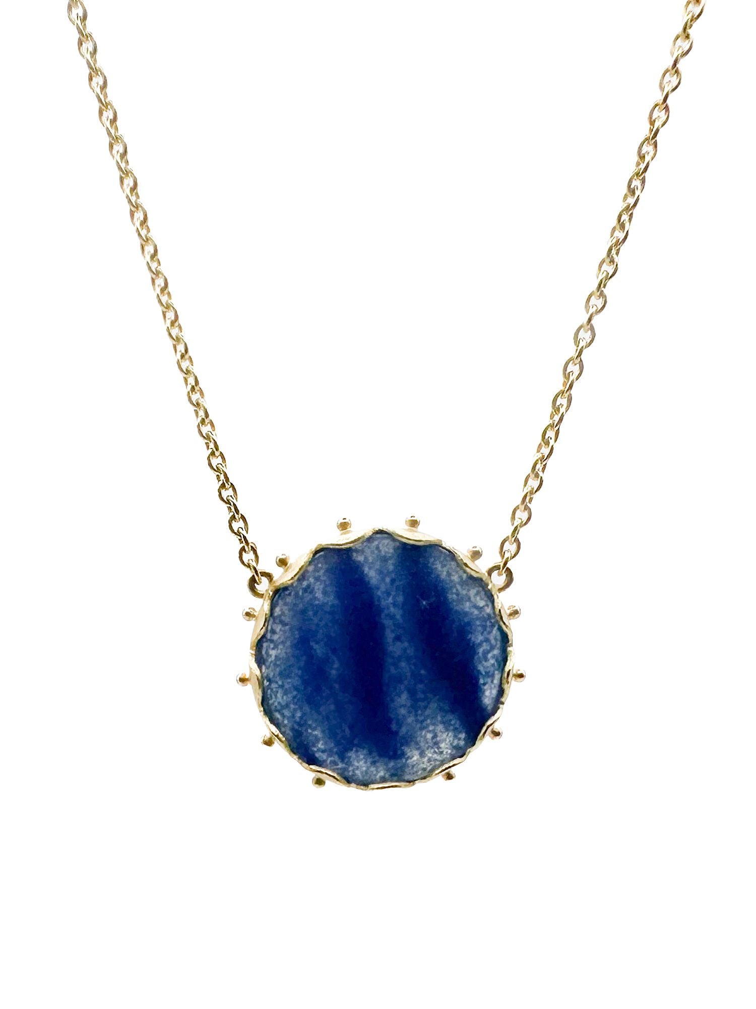 18K Gold Tanzanite Round Pendant Necklace: 18K yellow gold necklace featuring a faceted tanzanite round pendant. Necklace is 17 inches long, pendant is 5/8 inch. Weighs 5.5 grams.
